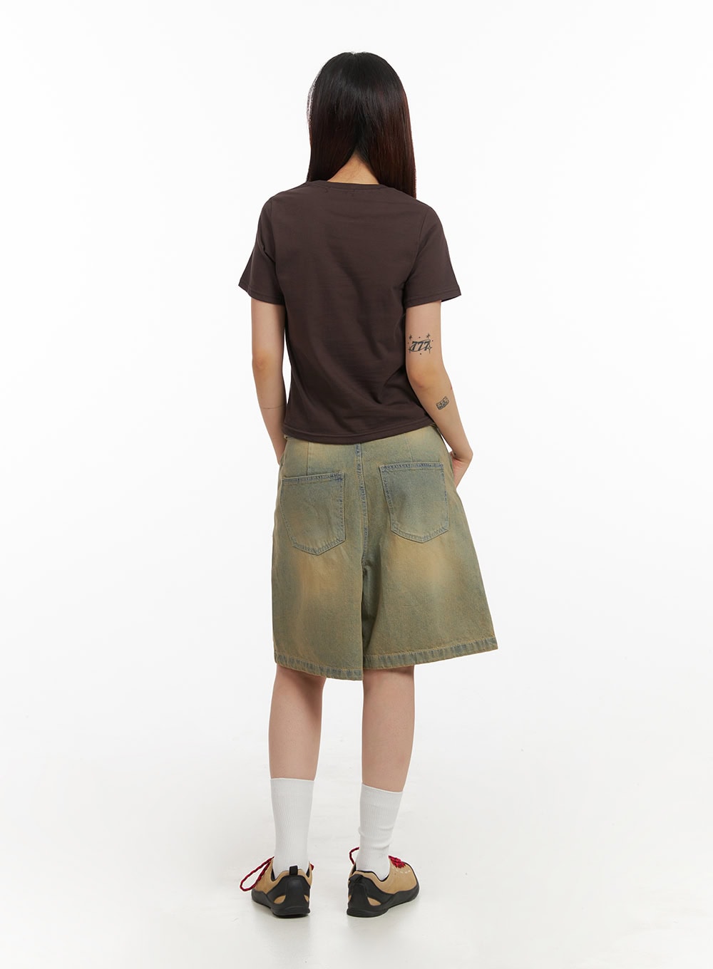 Vintage Washed Baggy Jorts IY410 in light blue, full-length back view on model, back patch pockets and wide flared hem showcased, worn with brown crop tee and white crew socks.