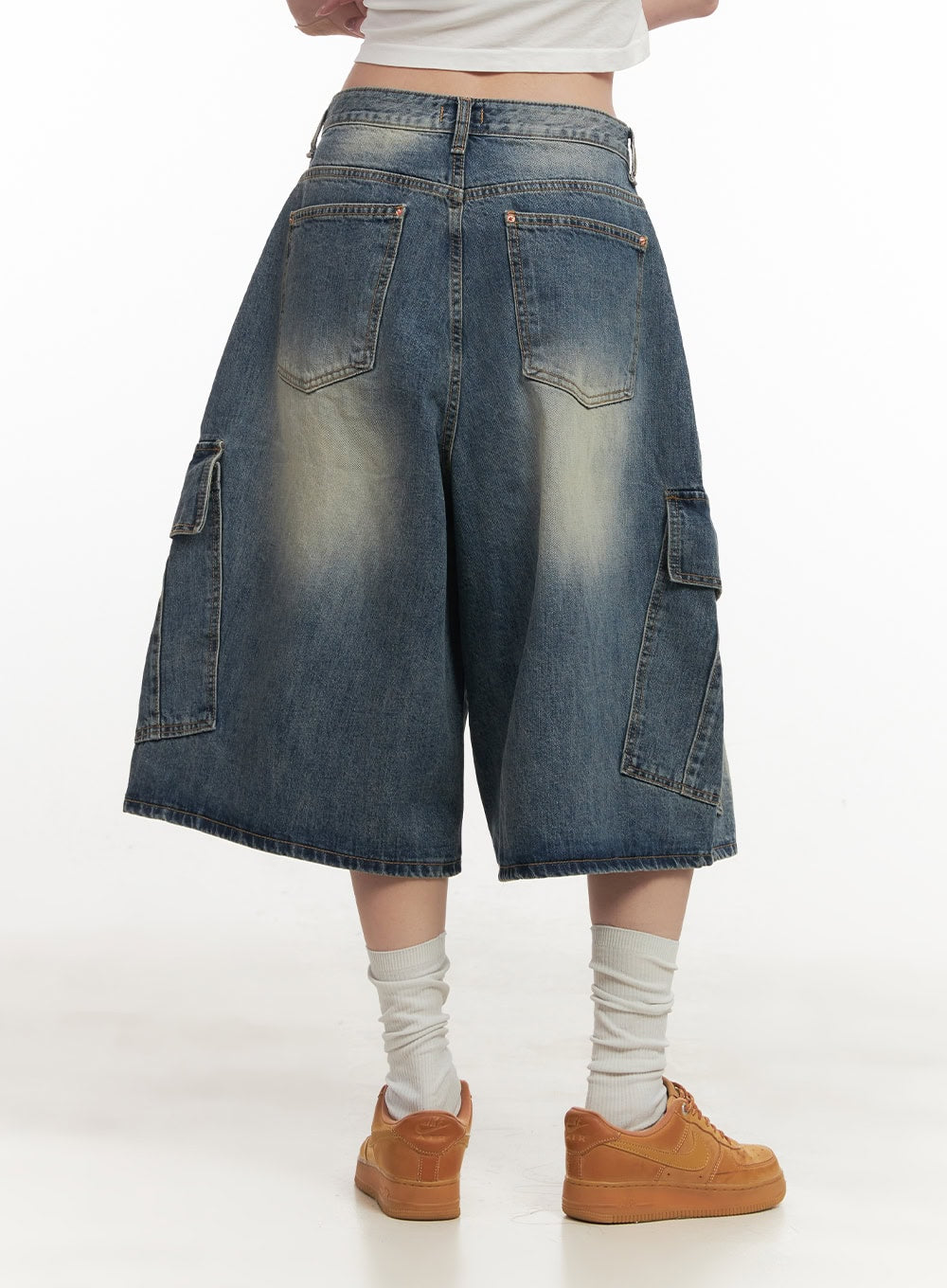 Cargo Bermuda Denim Shorts CF514 in dark blue, back close-up on model, washed cotton denim with dual back pockets and side cargo flap pockets, wide-fit midi length silhouette.