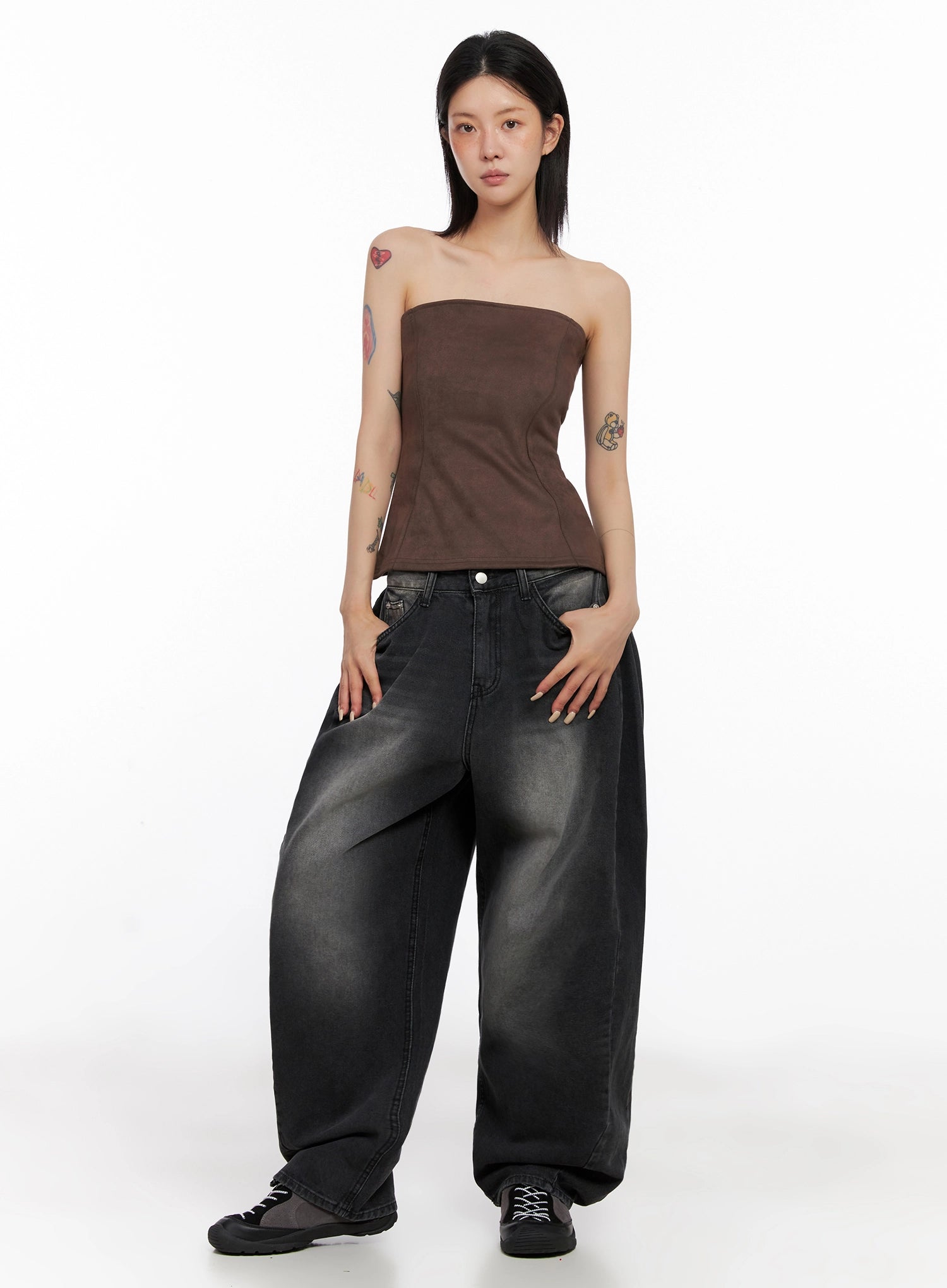 Ayra Dark Washed Baggy Jeans IS508 in dark grey, full-length front view on model, wide baggy cotton denim with faded wash, paired with brown strapless corset top and black sneakers, street style look.