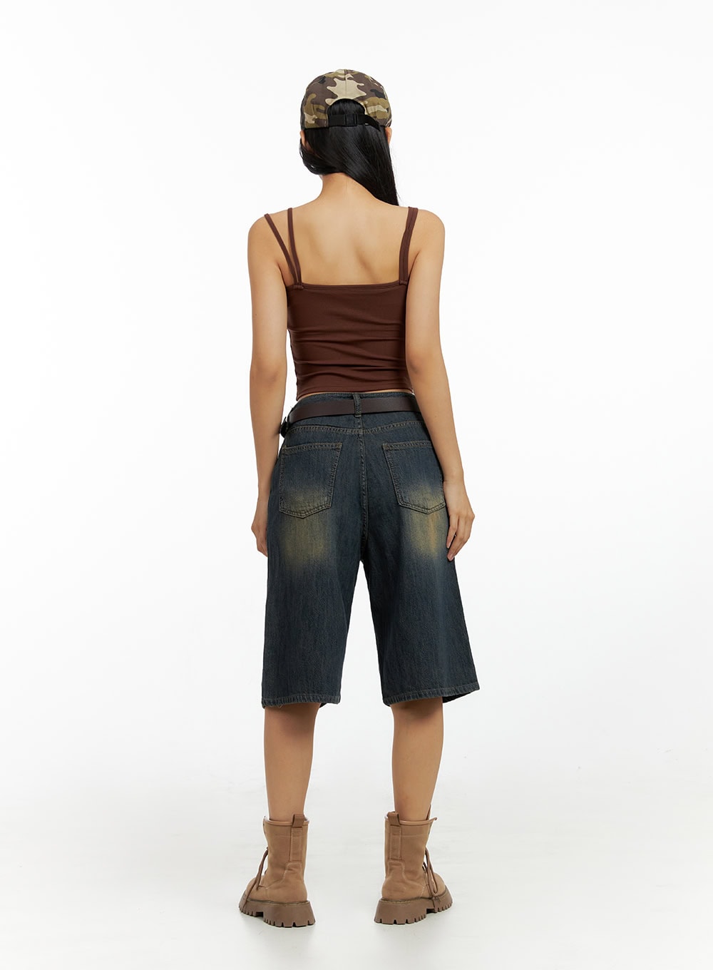 Dark Washed Wide Leg Jorts IL419 in dark blue, back full-length view on model showing back pockets and vintage yellow-tinted wash, styled with belt, brown cami, and camo cap.