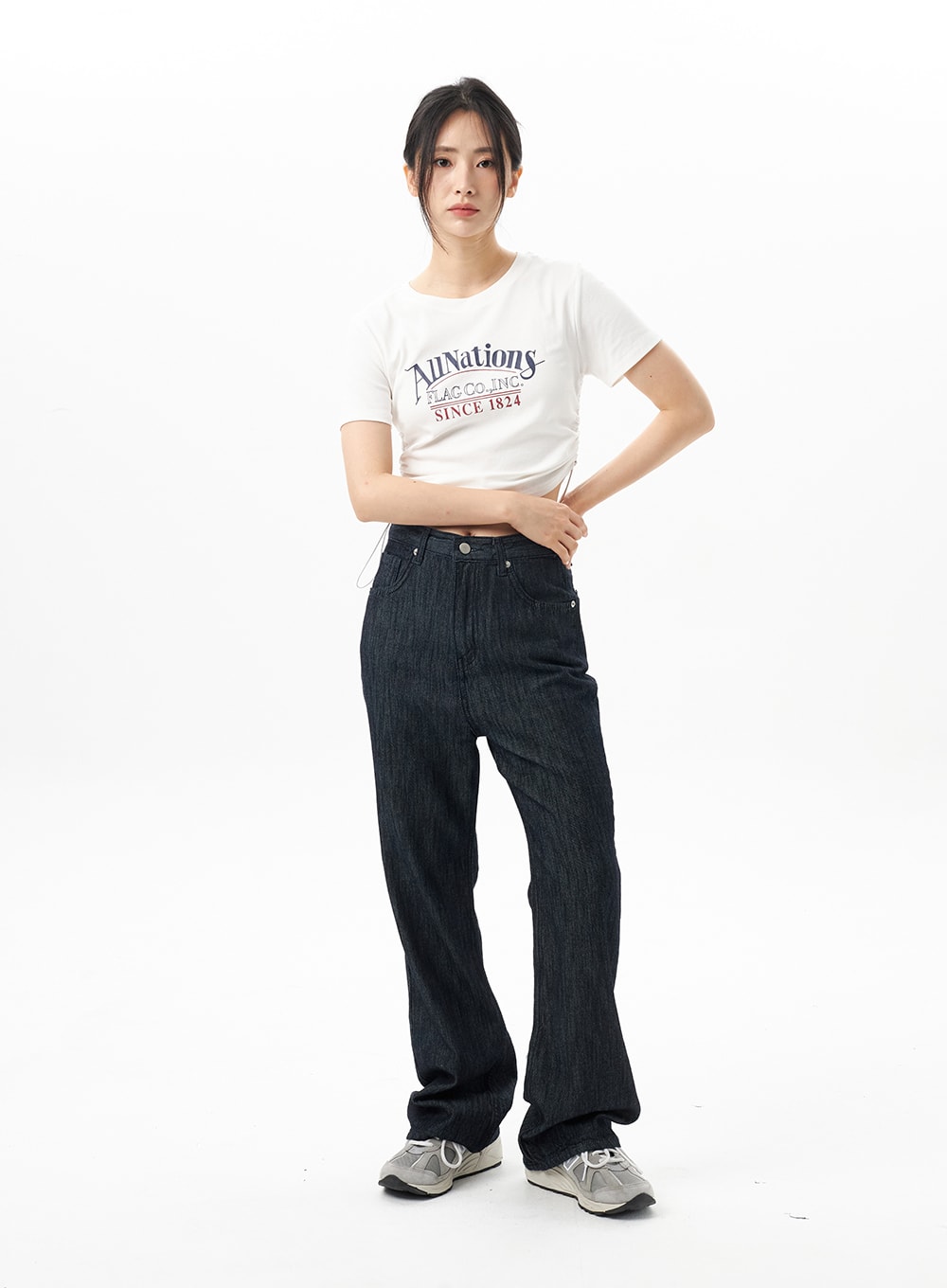 Dark Wash Mid-Rise Jeans OU314 in dark blue, front full-length on model facing camera, normal fit bootcut with subtle flare, paired with white AllNations crop tee and chunky sneakers.