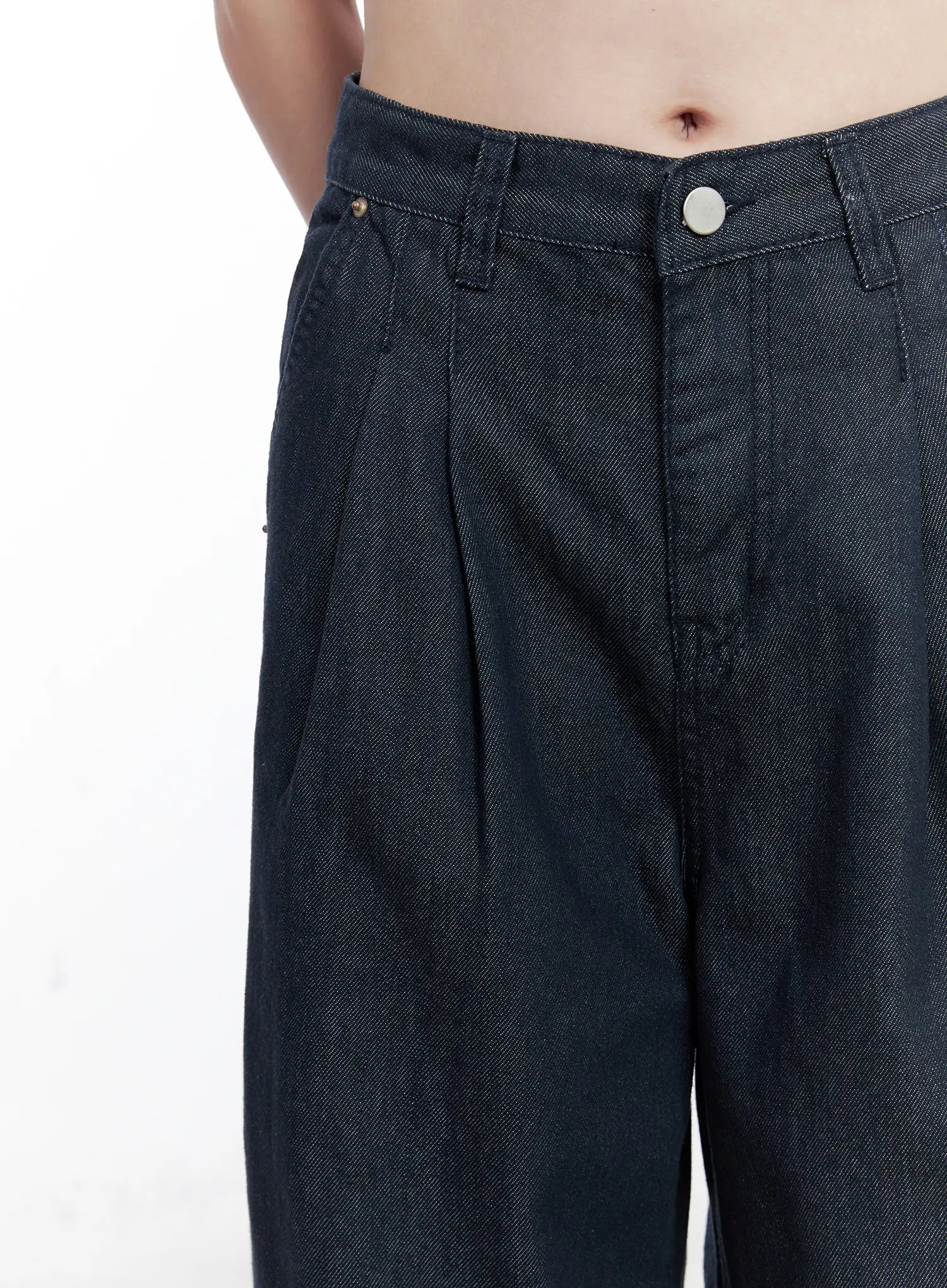 Lena Pintuck Baggy Jeans CO503 in dark blue, waist close-up on model, showing double pintuck pleats, button closure, gold rivets, and denim twill texture in detail.