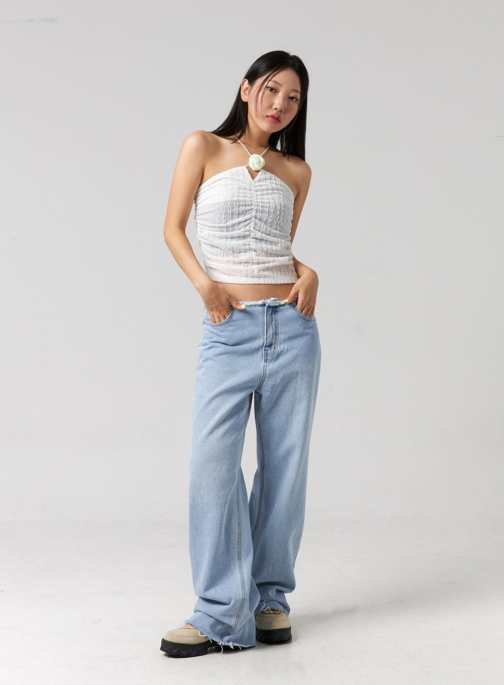 Cut Waist Wide Leg Jeans CG323 in light blue, full-body front shot on model, hands tucked in pockets, relaxed wide-leg cotton denim with frayed cut waist and raw-edge hem.