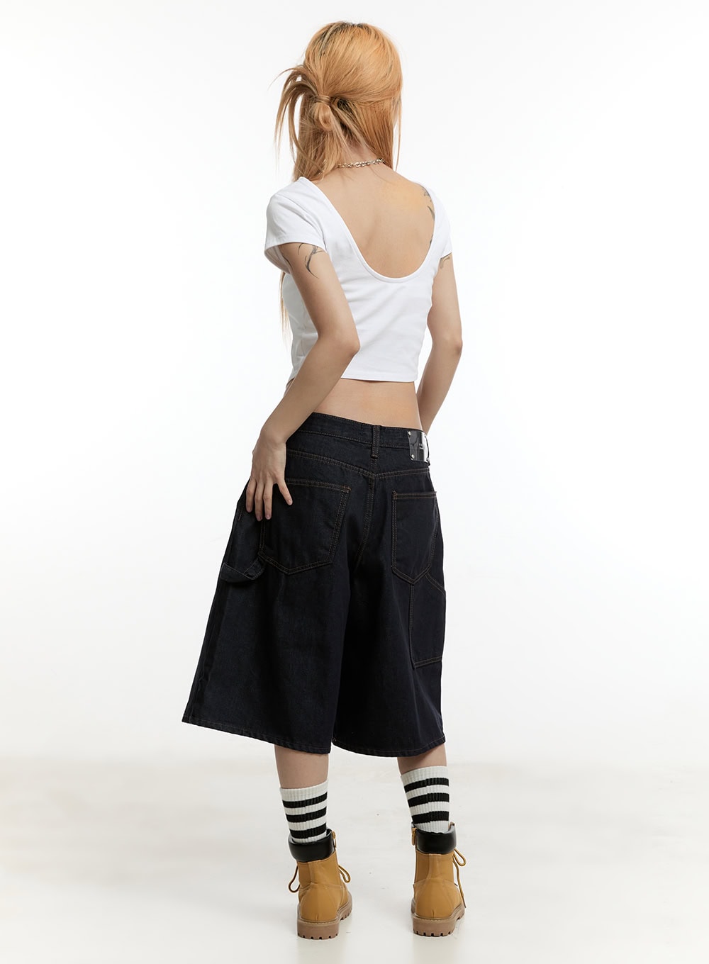 Carpenter Denim Wide-Leg Jorts CY501 in dark blue, full-body back shot on model, wide-leg midi silhouette with carpenter back pockets, paired with white backless crop tee and tan boots.