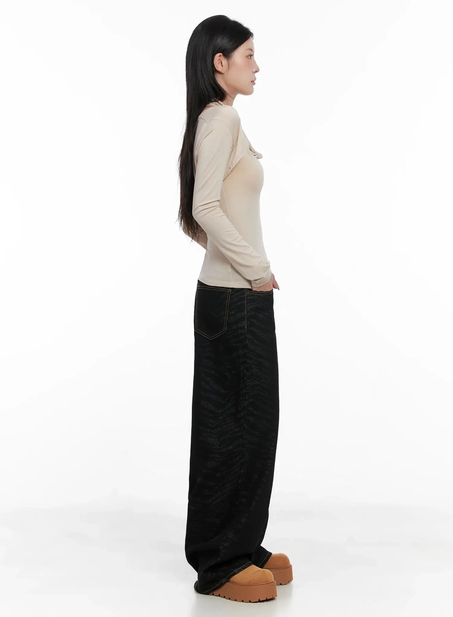 Freyja Animal Print Wide Leg Jeans IS508 in black, full-length side view on model, wide-leg zebra-print denim with long floor-grazing hem, paired with beige top and platform shoes.