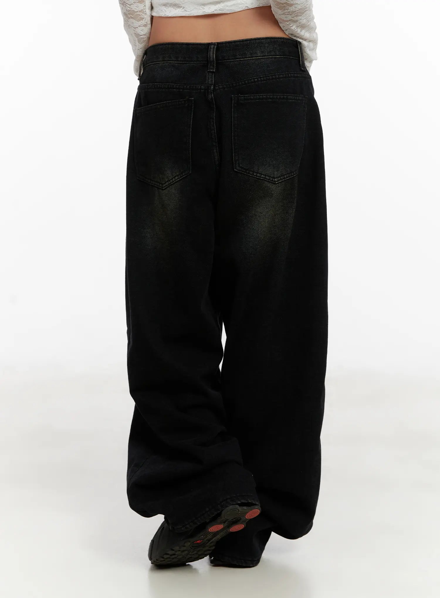 Myla Dark Wash Wide-Leg Jeans CD512 in dark black wash, back three-quarter view on model, full leg length with wide hem and back pocket detail, worn with white lace top.