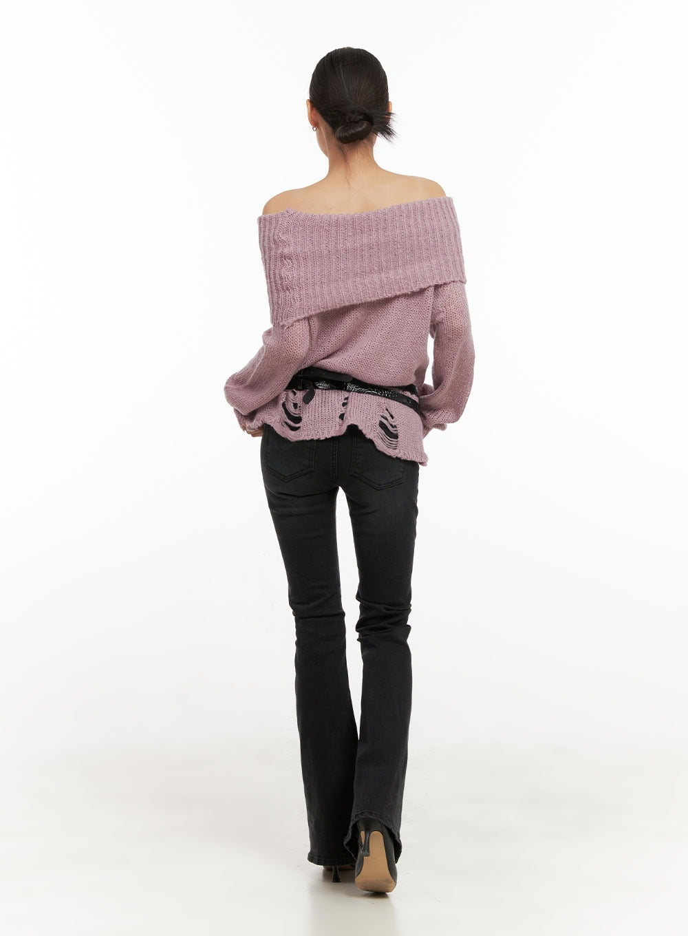 Belle Slim Fit Flared Jeans CD410 in black, full back shot on model walking away, low-waist flared silhouette paired with pink off-shoulder sweater and black belt.