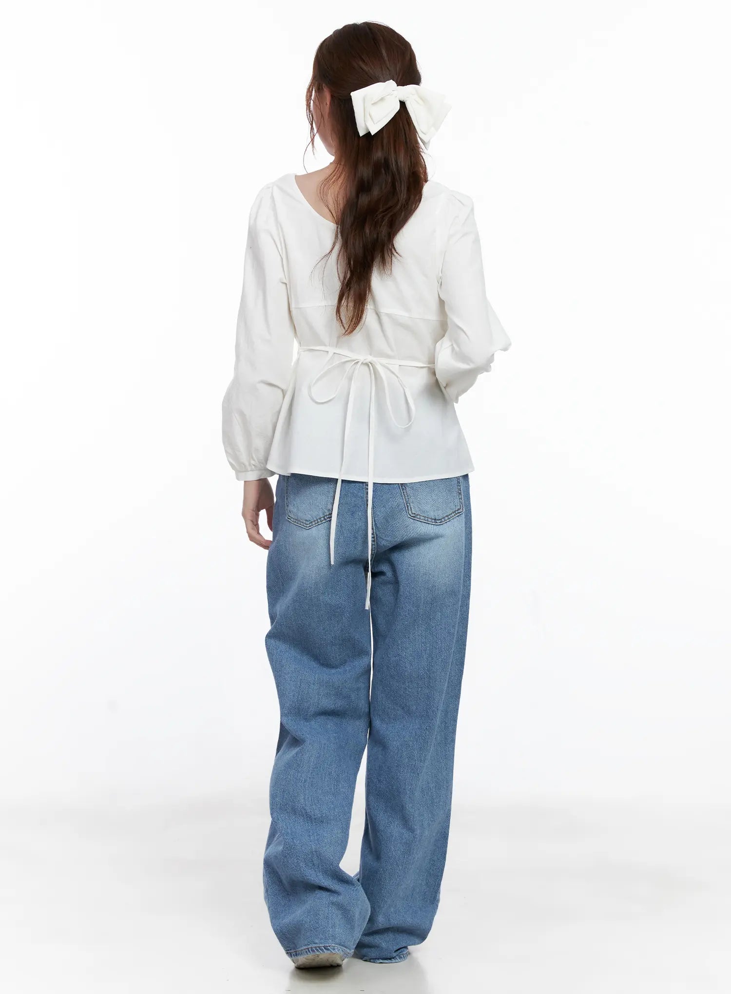 Jung Straight-Leg Washed Jeans CG521 in blue, back full-length shot on model, styled with a white tie-back blouse, showing back pockets and floor-grazing wide straight leg.