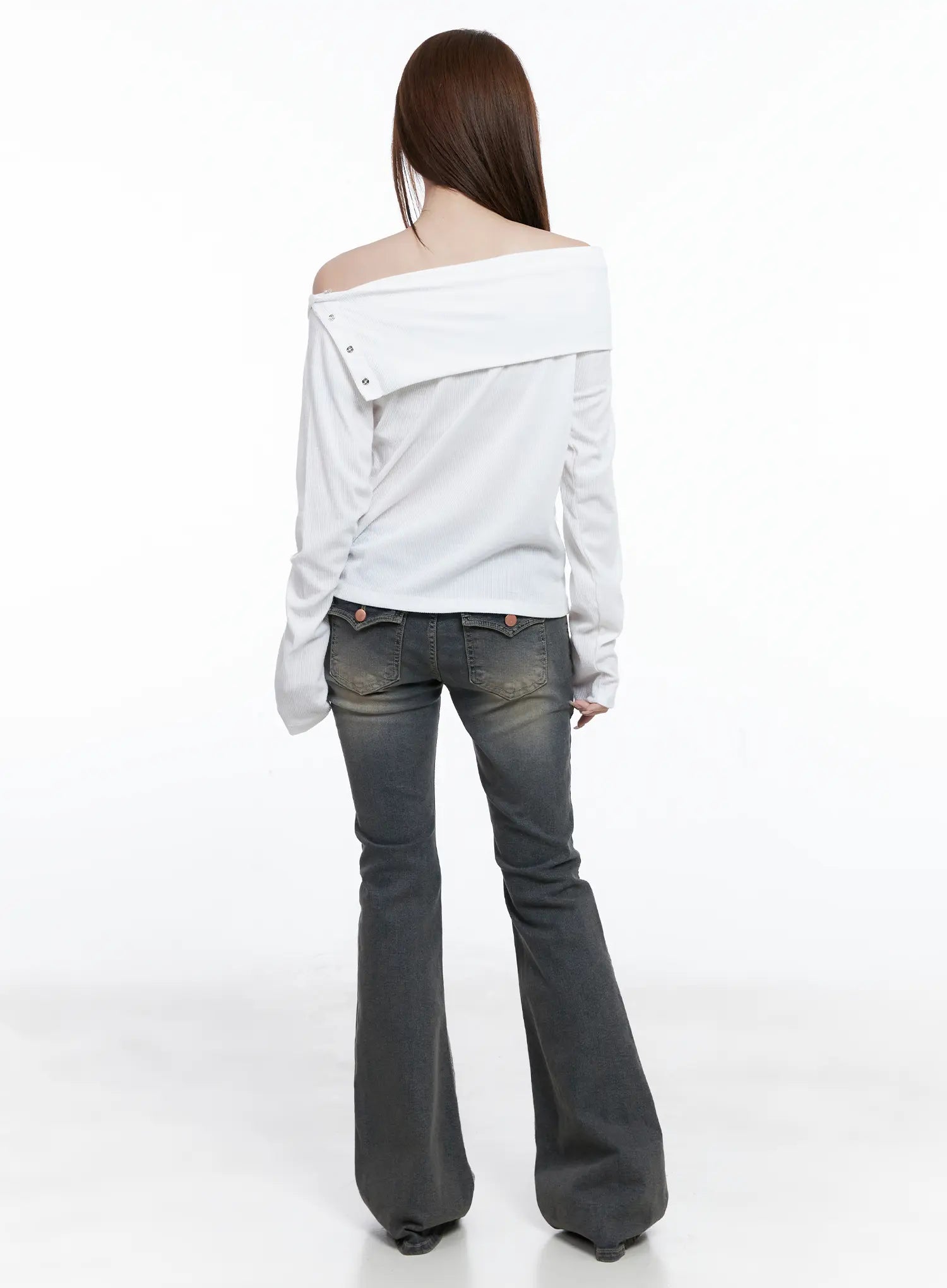 Sumin Low-Rise Flare Hip Pad Jeans CG529 in gray, back full-body shot on model, styled with white off-shoulder top, back flap pockets and wide flare hem visible.