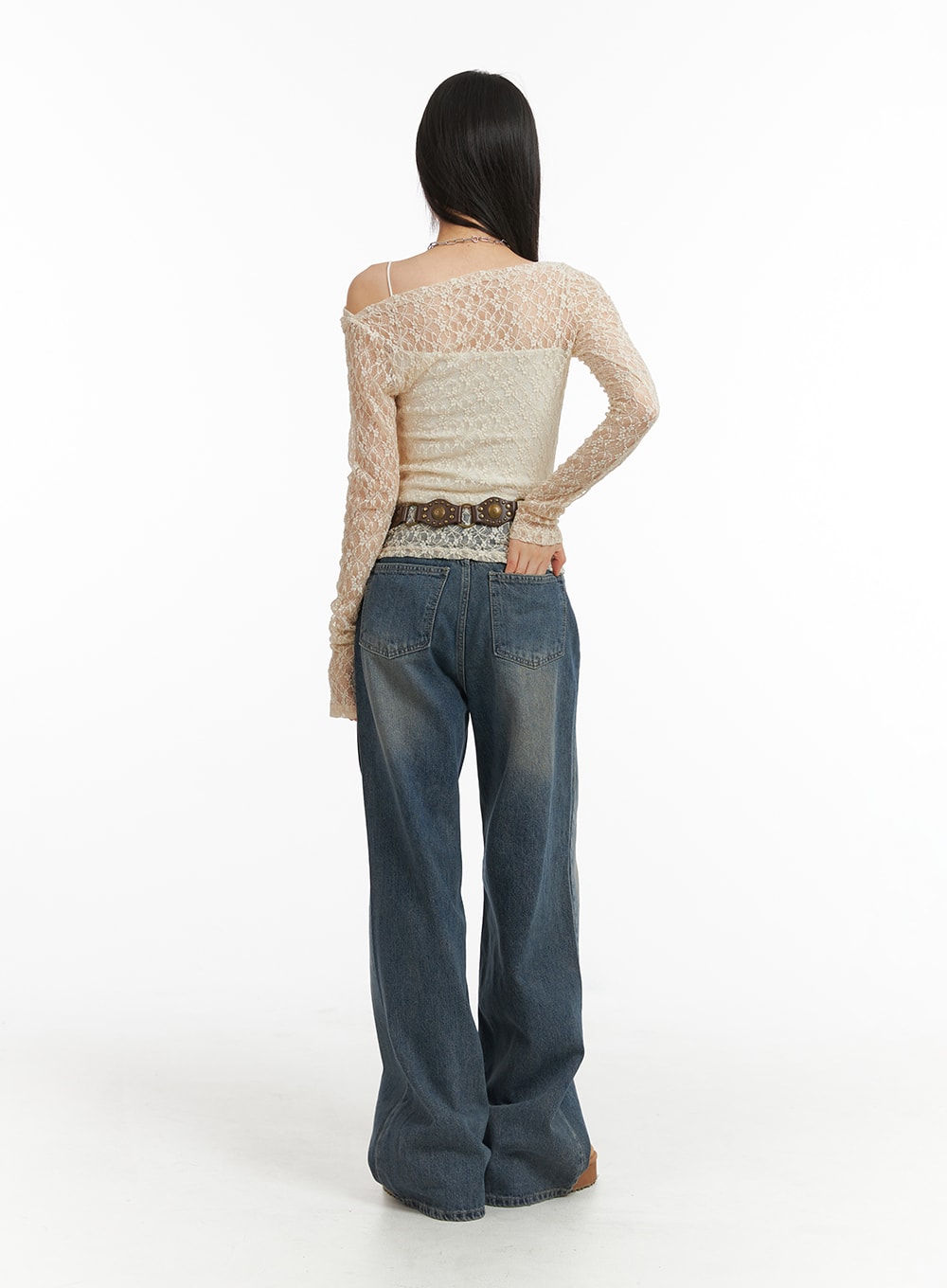 Wide Leg Denim Trousers CJ415 in washed blue, full-length back outfit shot on model, wide-leg cotton denim with vintage fade, paired with cream lace top and studded belt.