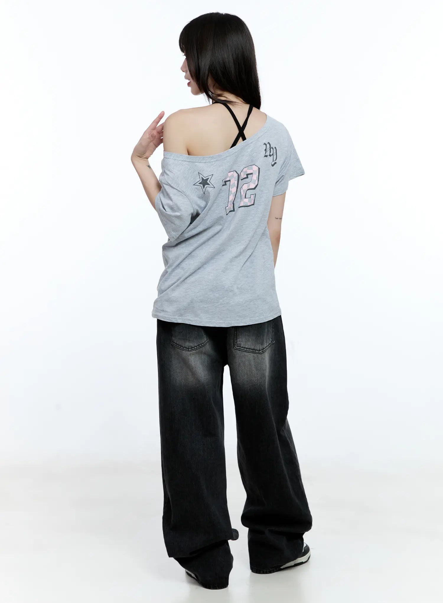 Gayeon Washed Wide-Leg Jeans CG507 in black, back full-body editorial shot, back pocket detail visible, washed black cotton denim, styled with off-shoulder graphic tee.