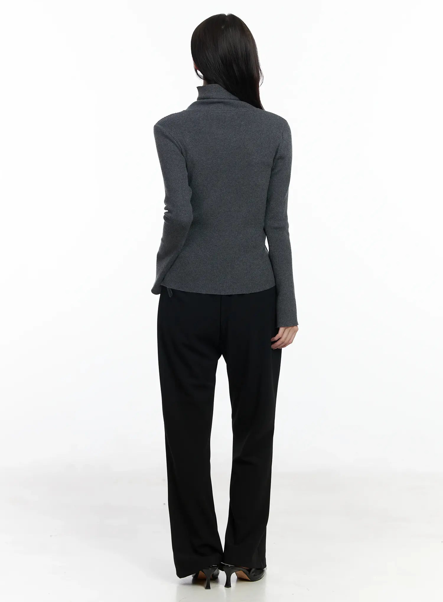 Hip Pad Slacks IJ529 in black, back full-length on model, rear profile showing smooth hip-pad fit and bootcut flare, paired with grey ribbed knit.