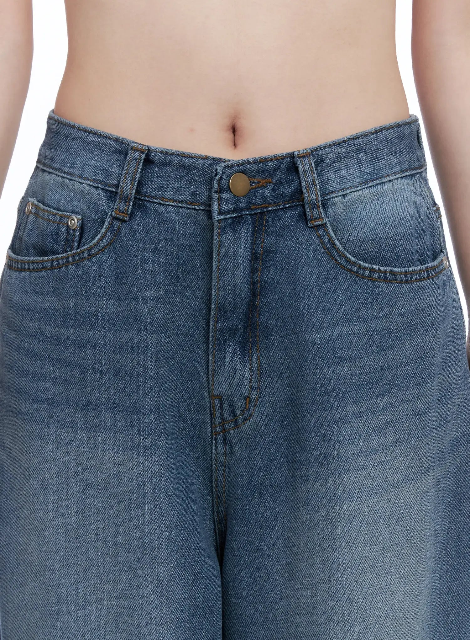 Margot Low-Rise Washed Wide-Leg Jeans CS501 in dark blue, waistband close-up on model, bronze button, front pockets, and contrast topstitching on washed cotton denim.
