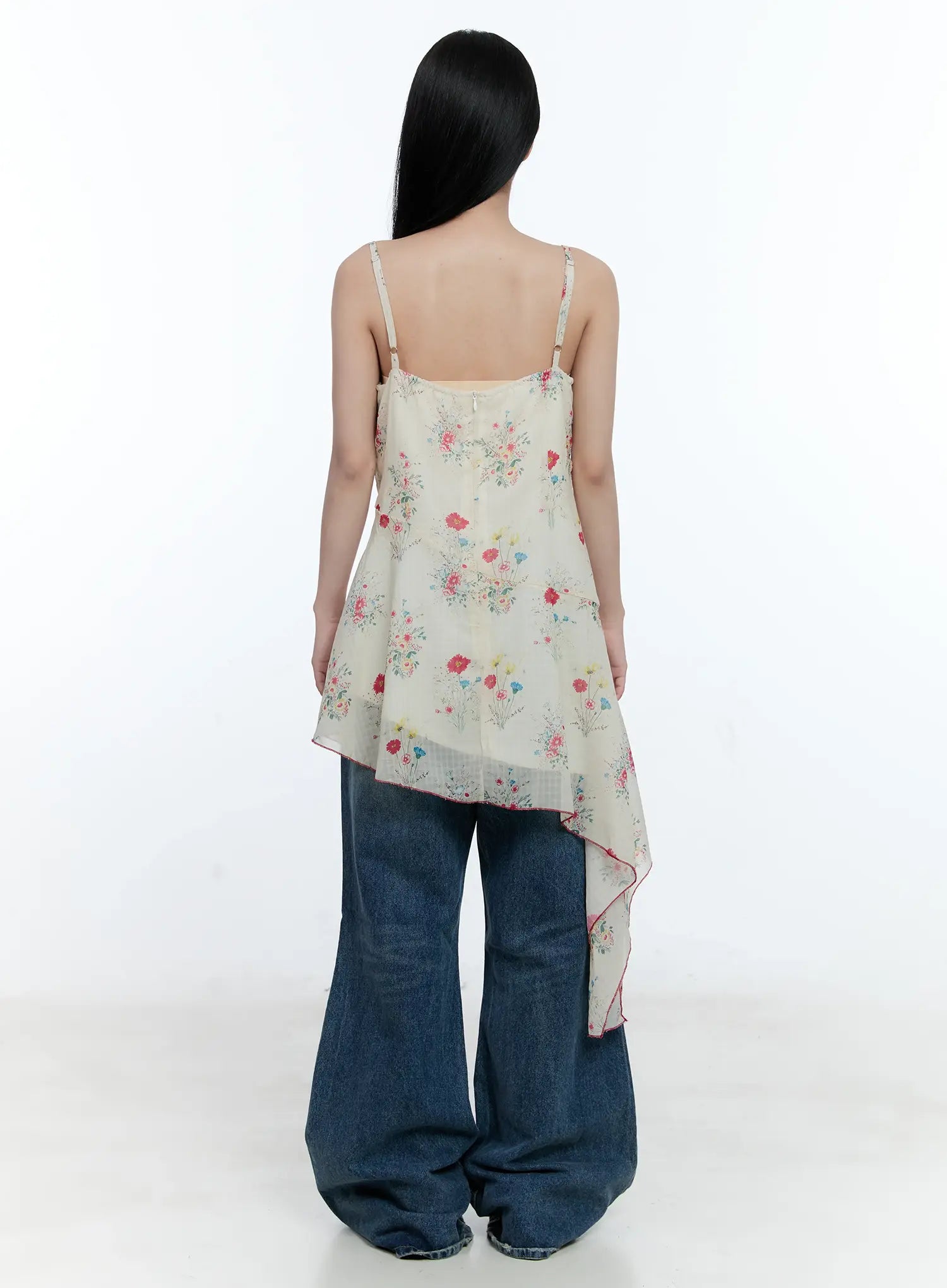 Gabi Distressed Semi-Flared Denim Jeans CG501 in dark blue, back outfit shot, paired with floral asymmetric cami, wide washed legs and knee distressing partly visible from behind.