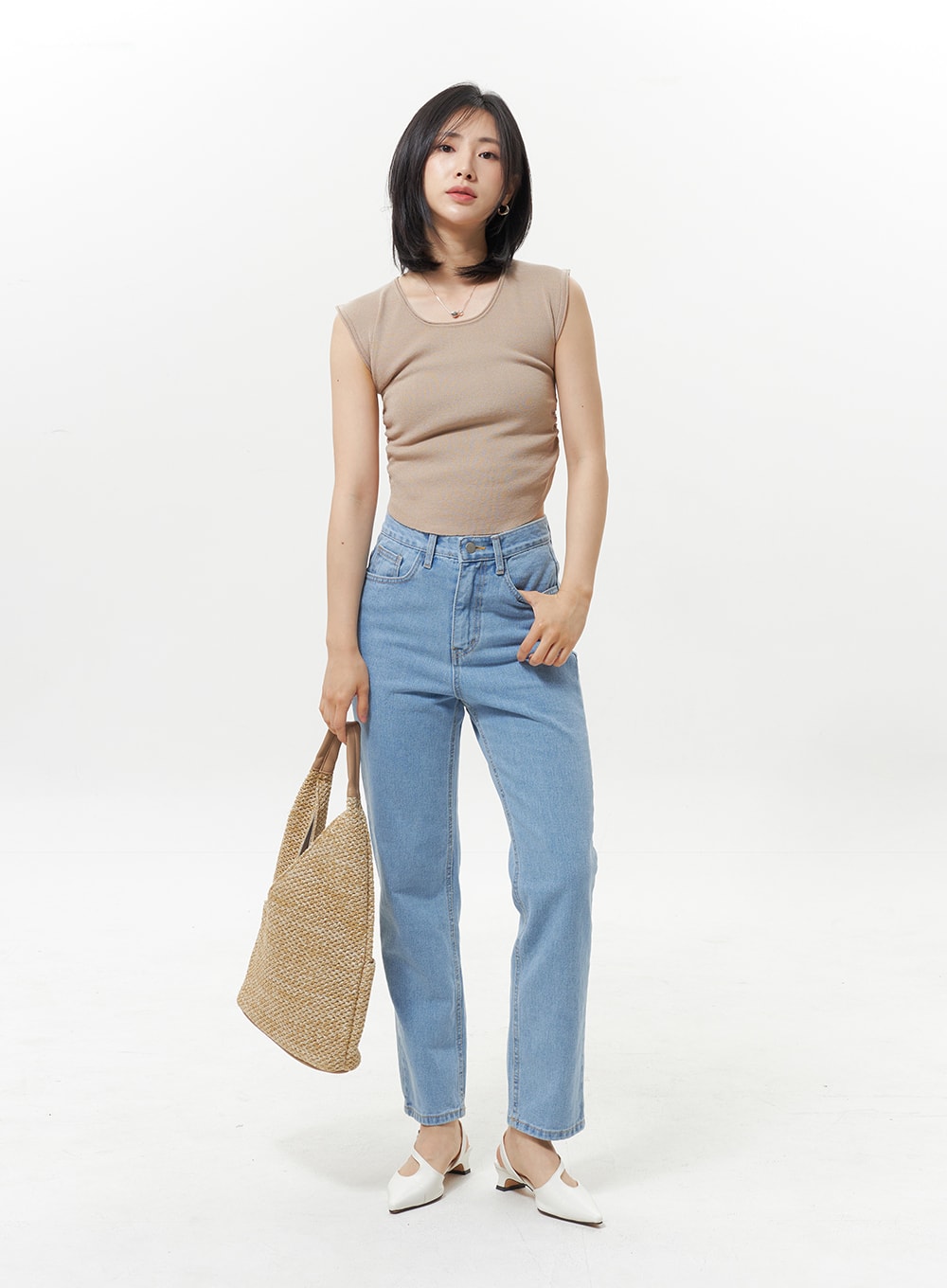 High Waist Jeans OY330 in light blue, full-front model shot with styling, straight-fit denim paired with beige tank top and woven straw tote bag, white slingback mules.