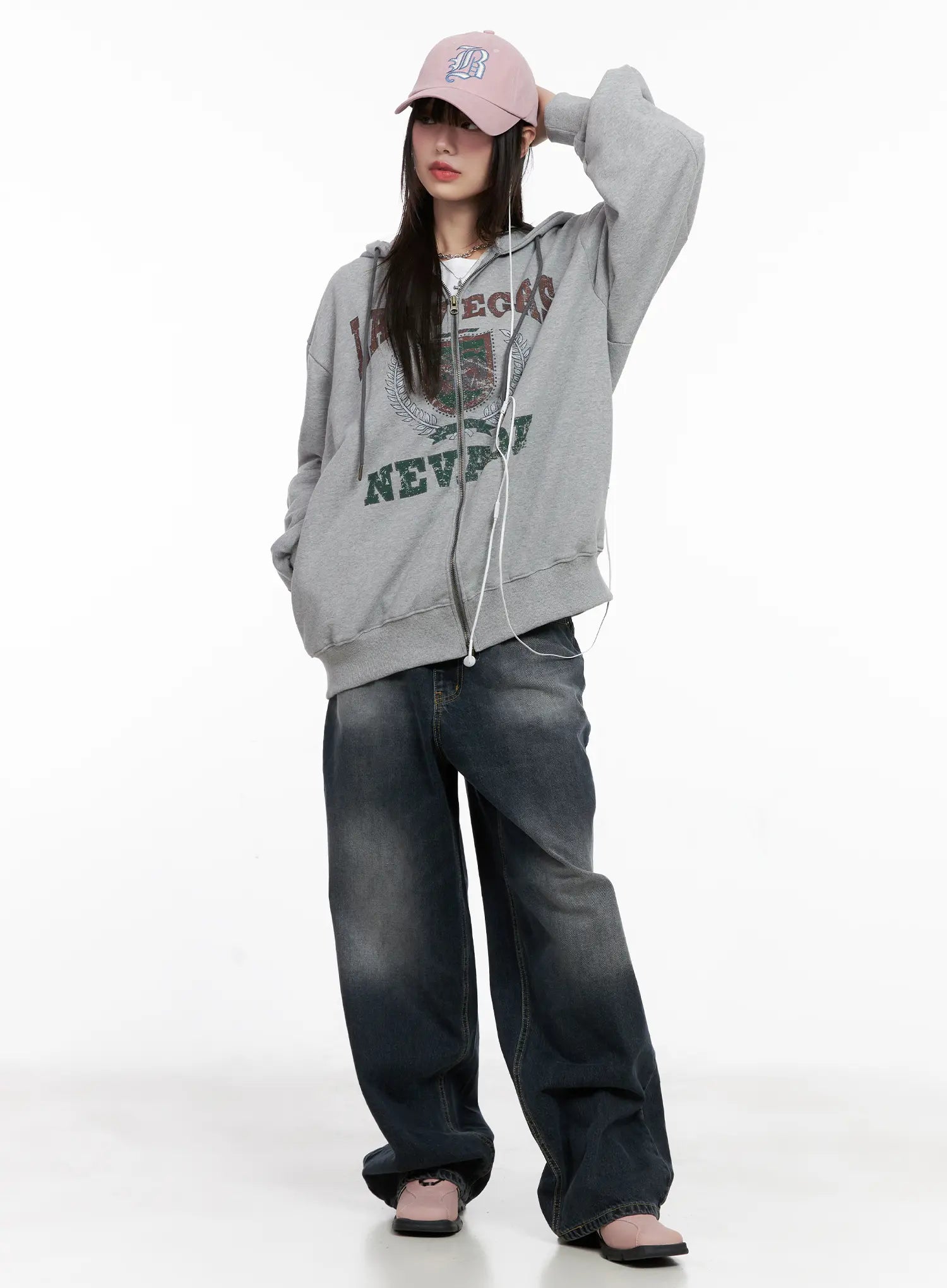 Celi Vintage Wash Wide-Leg Jeans CG515 in dark vintage wash, full front view on model, baggy wide-leg silhouette styled with oversized grey graphic zip-up hoodie and pink baseball cap.
