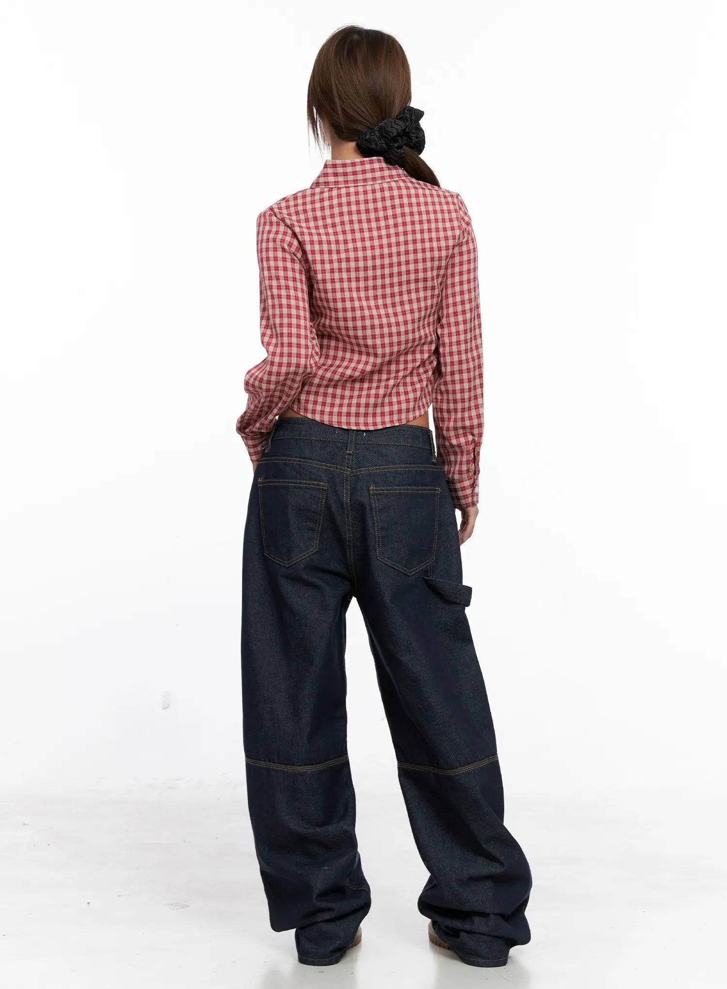 Relaxed Fit Dark Denim Jeans CS522 in dark blue, back styling shot, model in red plaid crop shirt, back pocket and carpenter detail visible, exaggerated wide leg, tan boots.