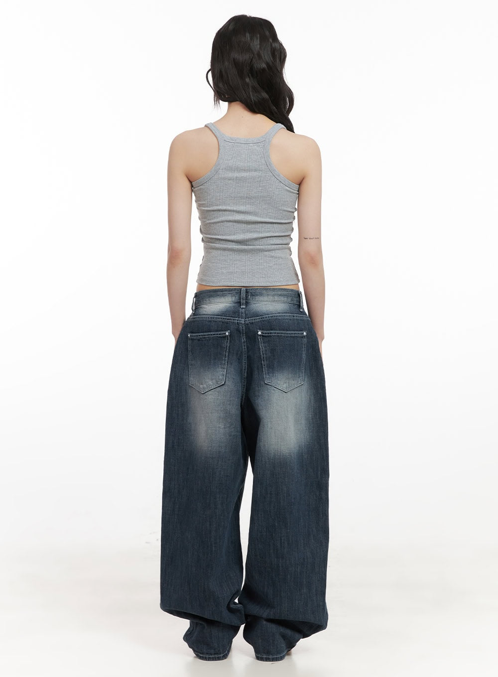 Alison Destroyed Baggy Jeans CJ523 in dark blue, full back shot on model in gray racerback tank, showing back pockets, washed indigo fade, and extra-wide bagging leg silhouette.