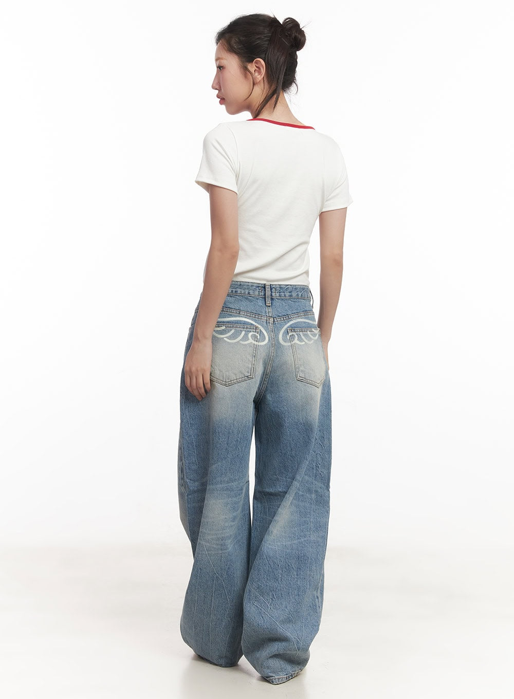 Lumira Back-Detail Washed Wide Leg Jeans CA530 in blue, back full-length view on model, angel wing back pocket detail, heavily washed denim, styled with white red-trim crop tee.