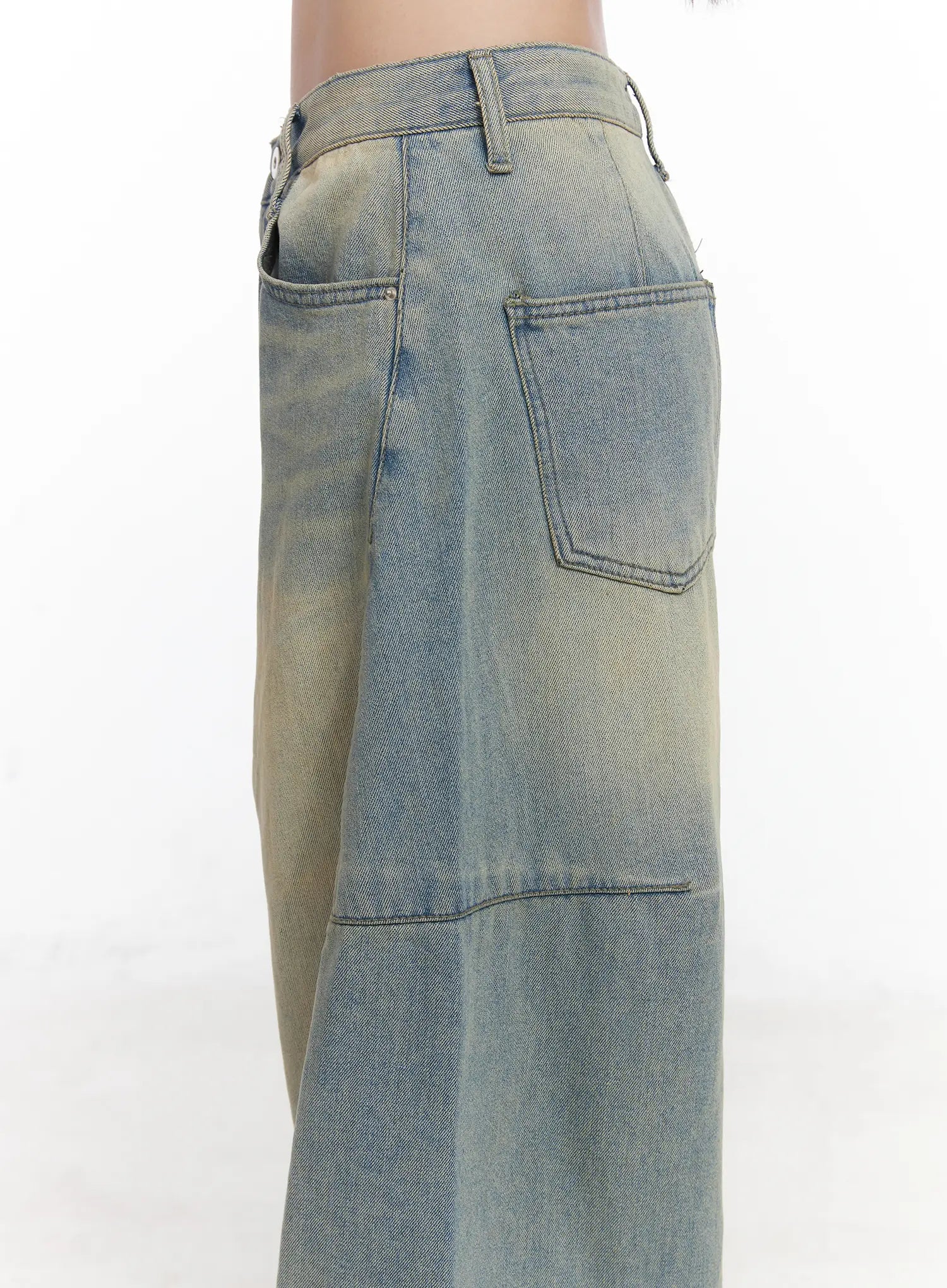 Lyla Washed Wide Leg Jeans CD530 in light blue, side close-up of waist and hip area on model, detail of back patch pocket, belt loop, low-rise waistband, and washed denim panel seam.