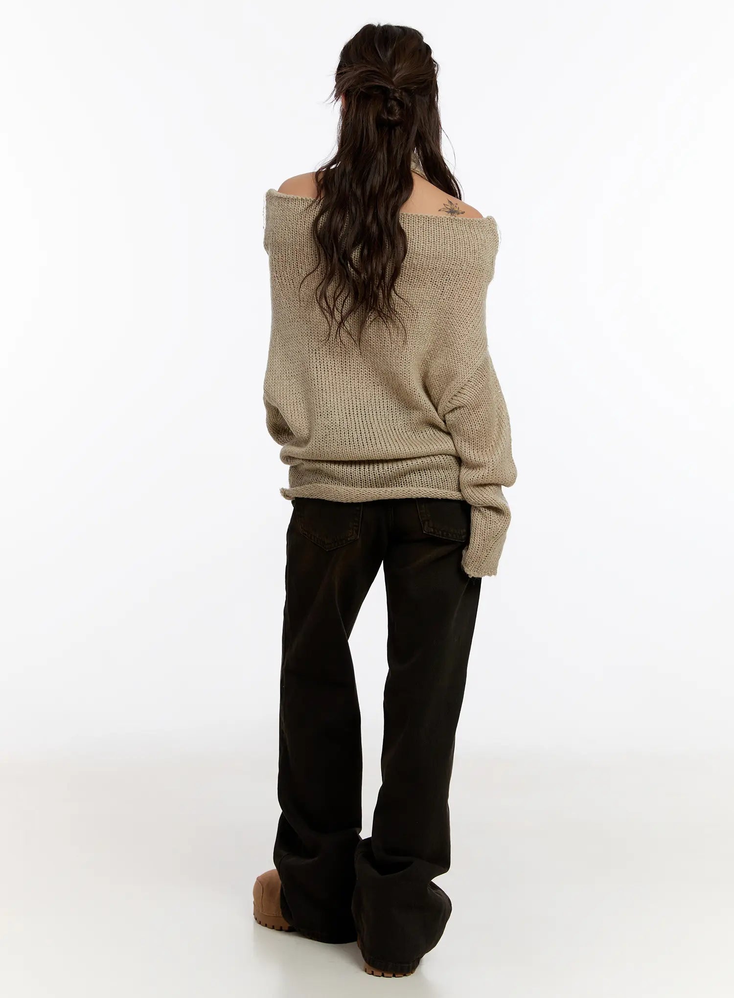 Mael Low Rise Straight Jeans CN527 in black, full back view on model, styled with beige off-shoulder knit sweater, showing full straight-leg length and pooled hem at clogs.