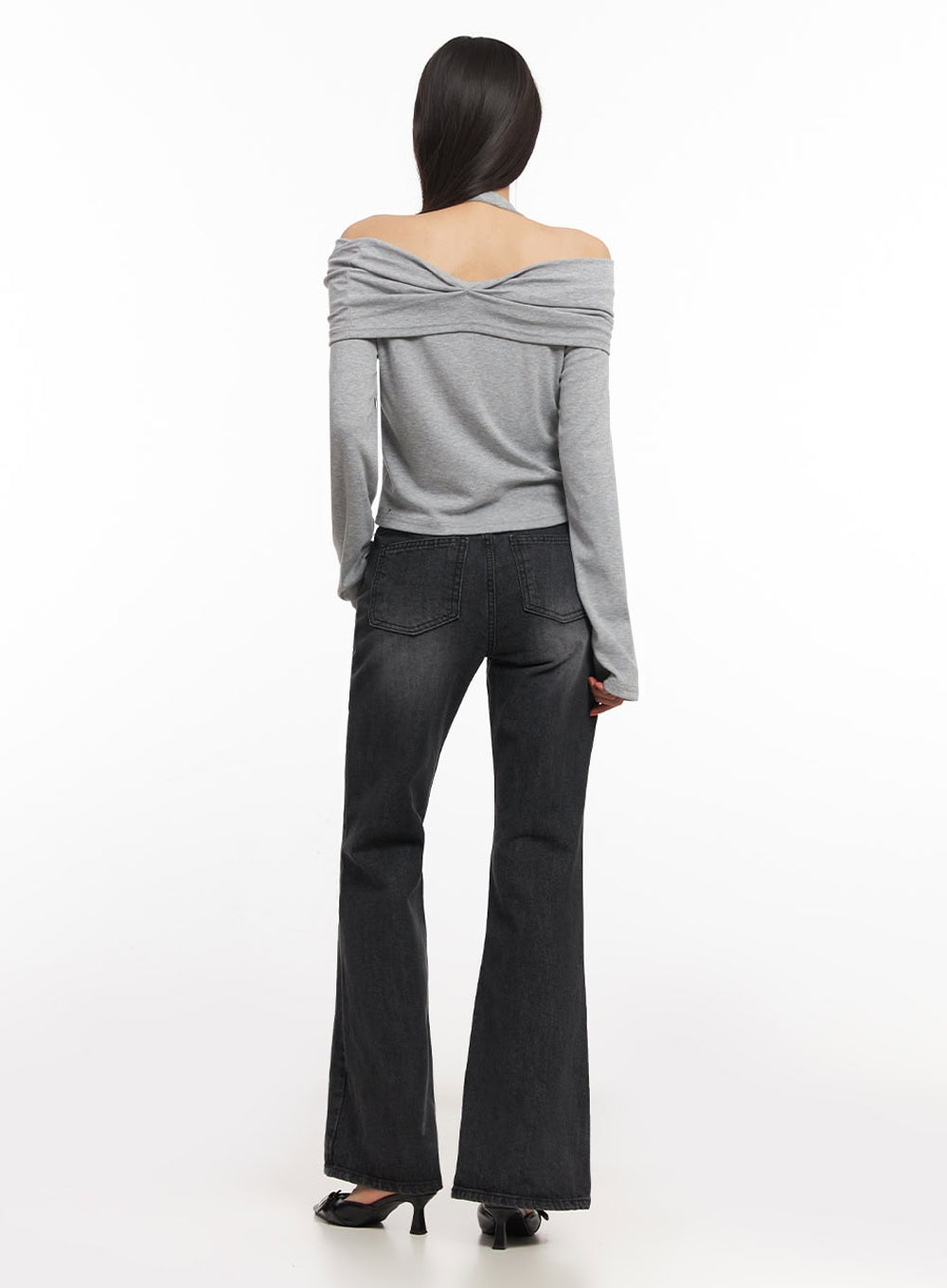 Joanna Washed Flared Jeans IA504 in washed black, full back view on model, two back patch pockets, flared hem from knee down, cotton denim with subtle fade, paired with grey off-shoulder top.