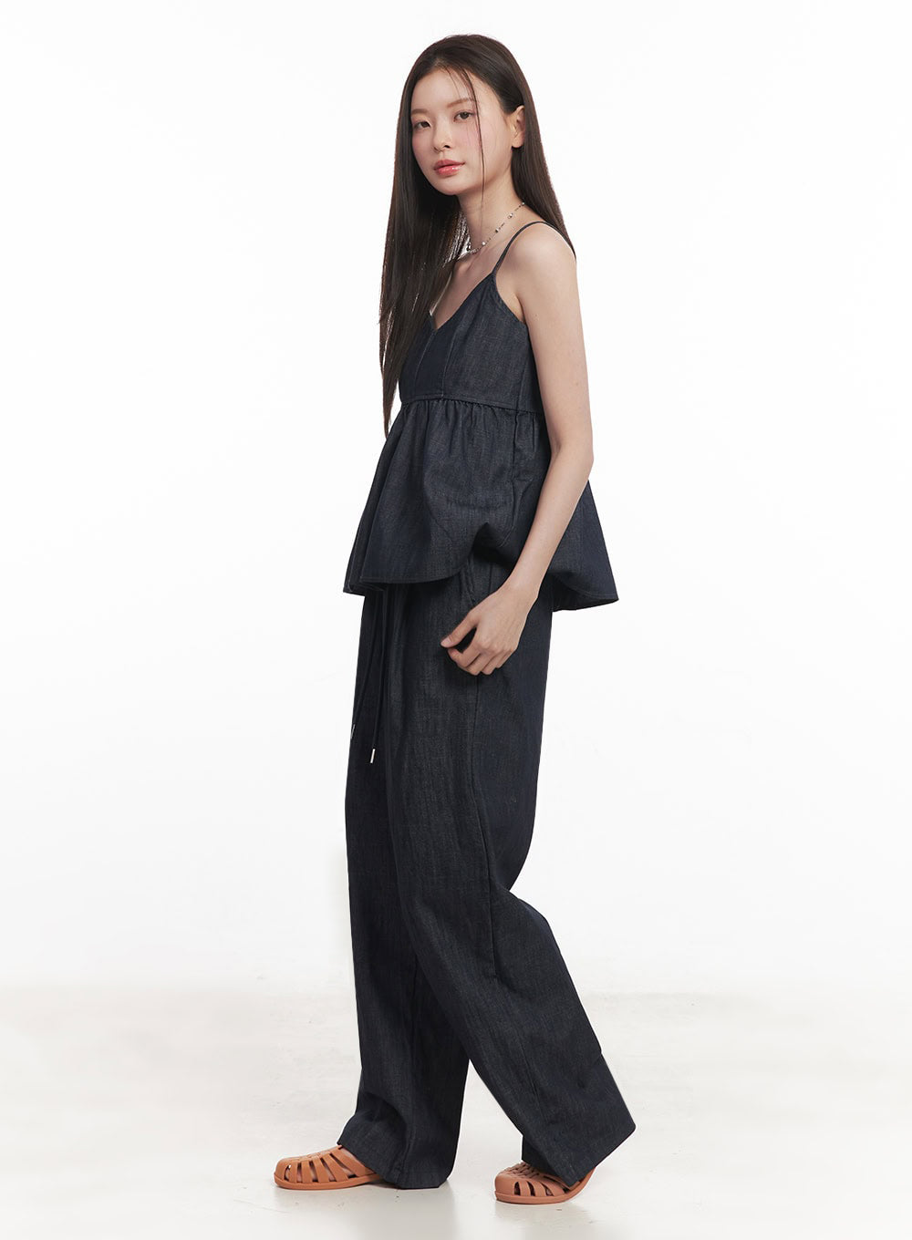 Cotton Denim Wide-Leg Pants IY509 in dark navy, side full-length view on model, showing wide-leg volume and drawstring waistband drape, paired with denim cami top and tan flat sandals.