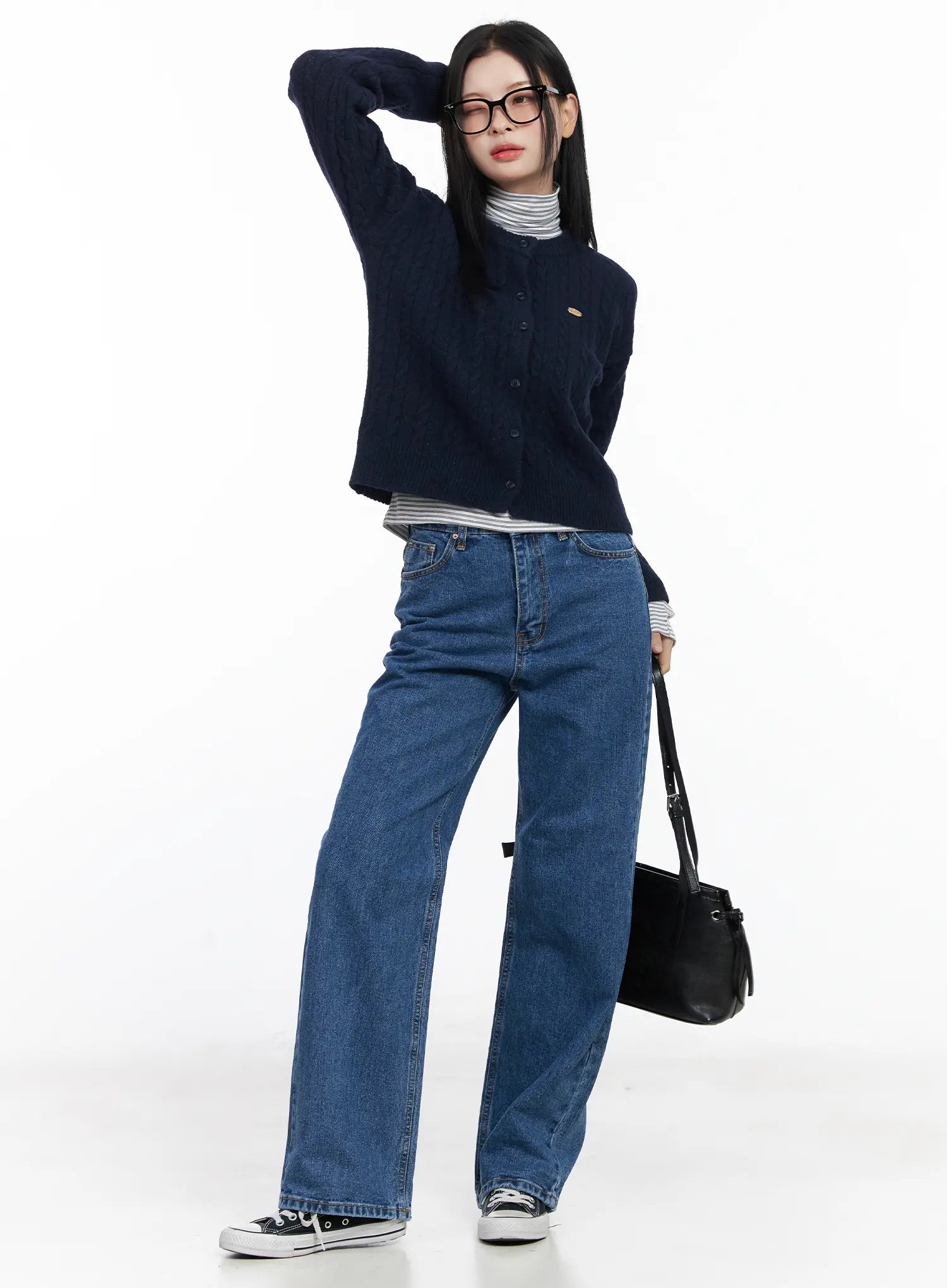 Aila Relaxed Fit Jeans CJ519 in blue, full-body styled shot on model wearing glasses, wide-leg washed denim with navy cardigan, black bucket bag, casual look.