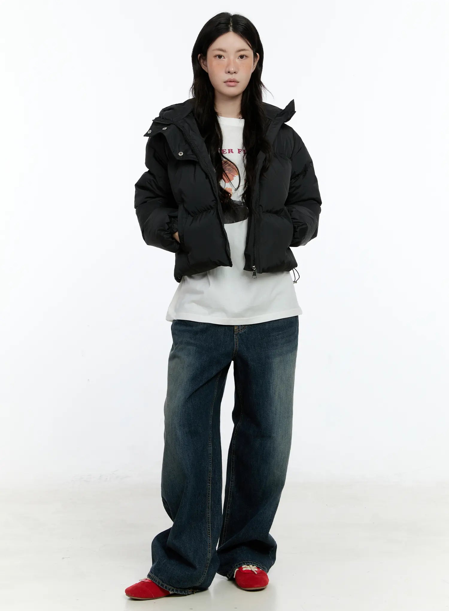 Hunter Washed Wide Leg Jeans CN517 in dark blue, front full-body on model, winter outfit with black cropped puffer, white graphic tee underneath, red sneakers, straight-on pose.