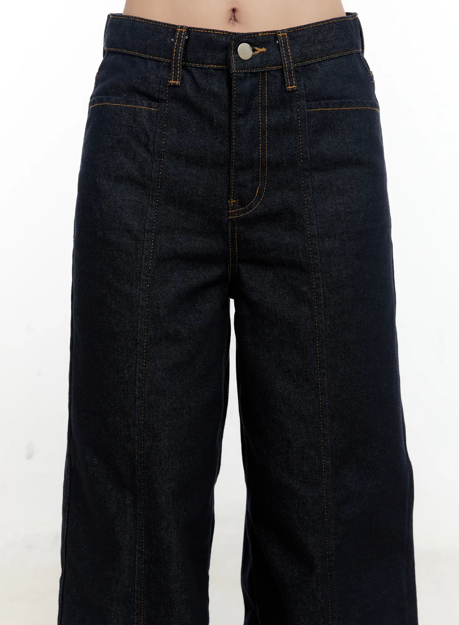 Nala Wide-Leg Bootcut Jeans CN506 in dark blue, front waist close-up on model, single button fly, front patch pocket, and vertical center-seam topstitch detail clearly visible.