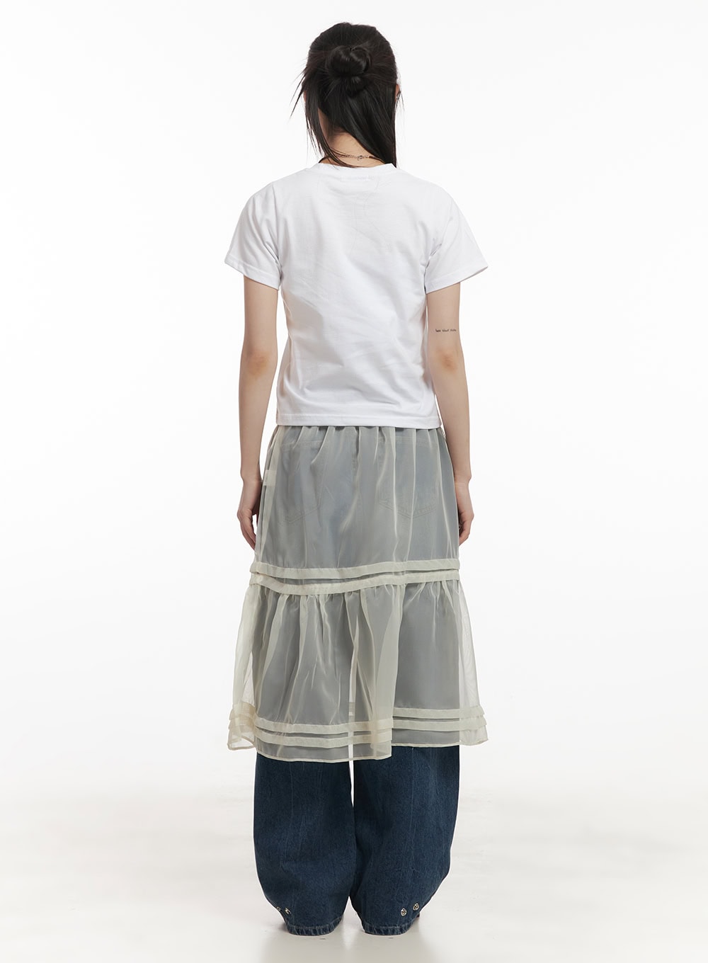 Bri Oversized Buttoned Baggy Jeans CF518 in dark blue, back full-length on model, worn under sheer organza midi skirt, wide leg hem with snap buttons visible, white tee.