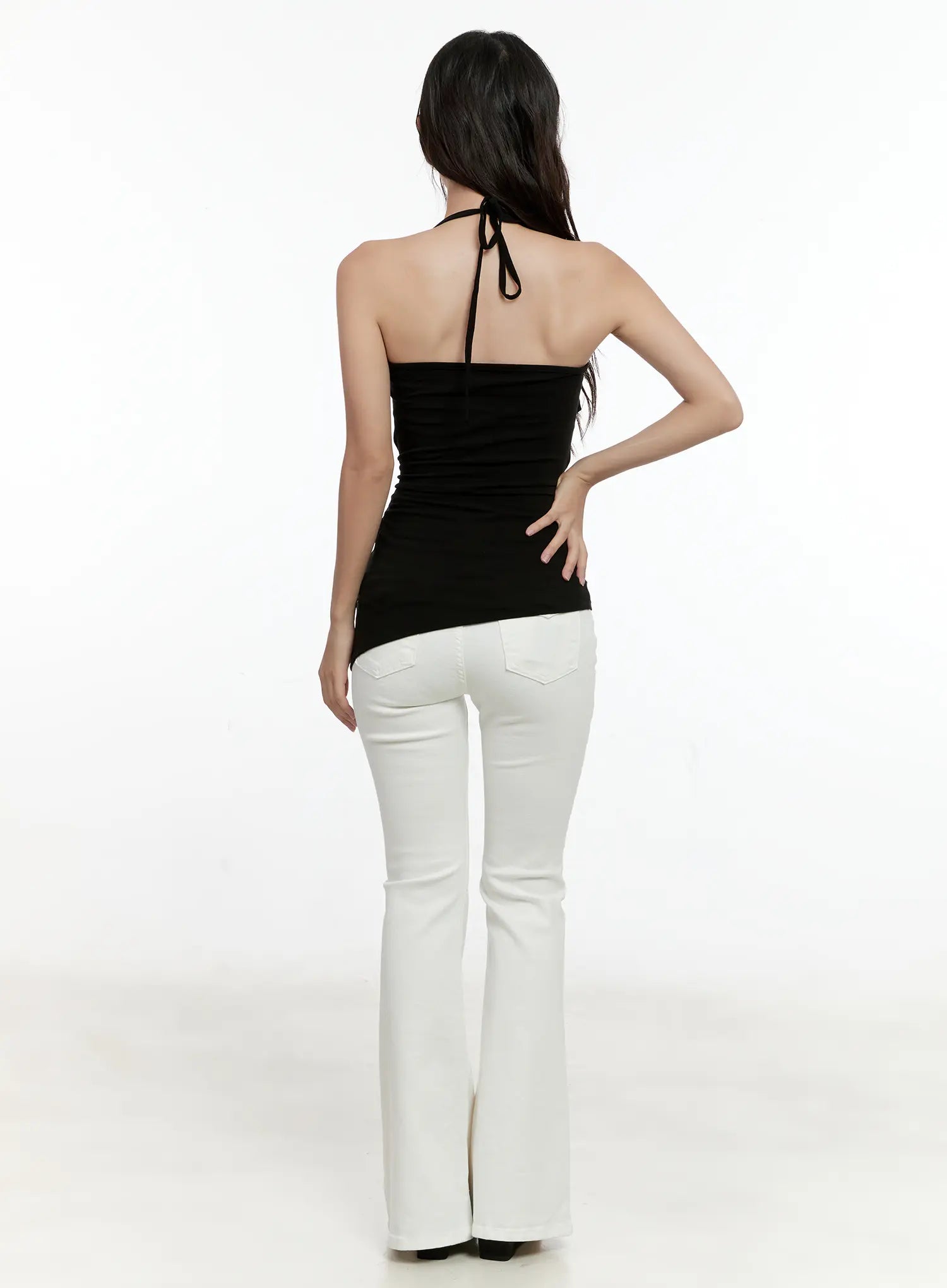 High-Waist Flare Pants CG501 in white, back full-body shot on model, paired with black halter top, flare leg and back pocket detail visible.