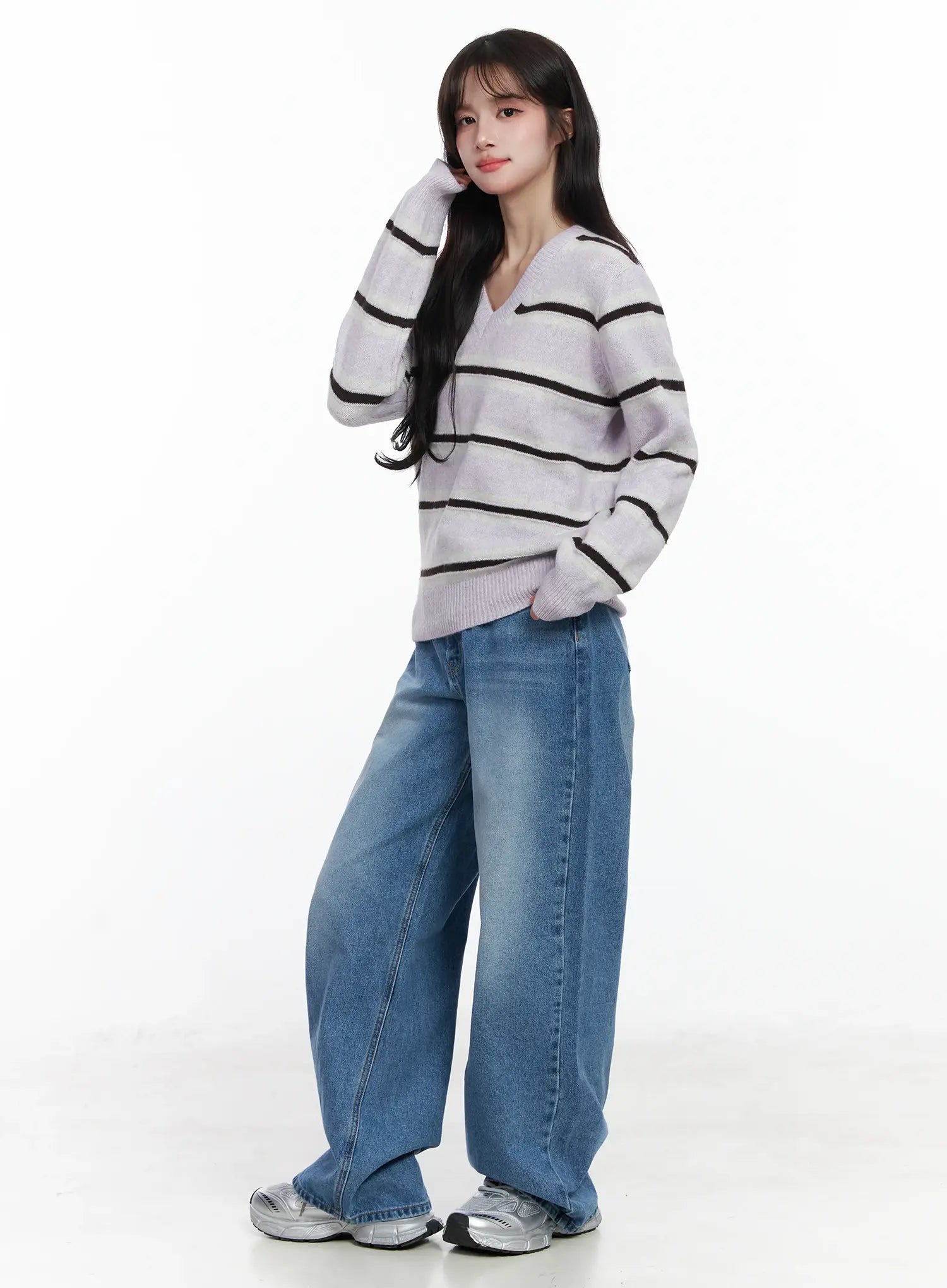 Iliana Wide Leg Jeans IJ529 in blue, full-body side-facing shot on model, baggy wide-fit washed cotton denim paired with striped lavender knit top, silver sneakers.