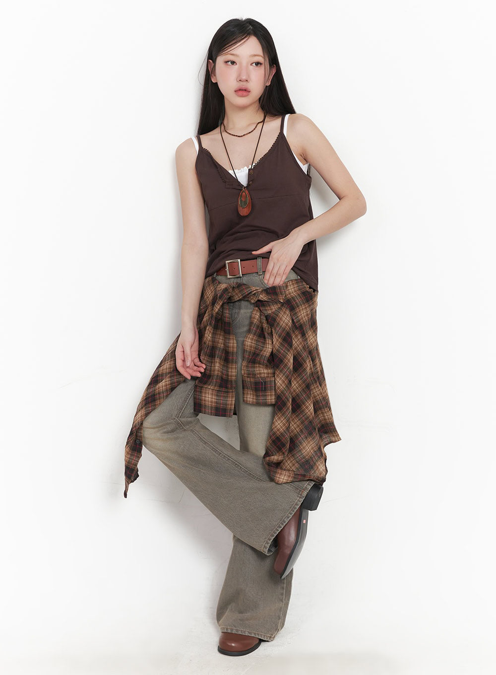Sherry Washed Slim-Fit Bootcut Jeans IM528 in vintage brown, full-length front editorial shot on model, plaid shirt tied at waist over washed bootcut denim, styled with brown cami and belt.