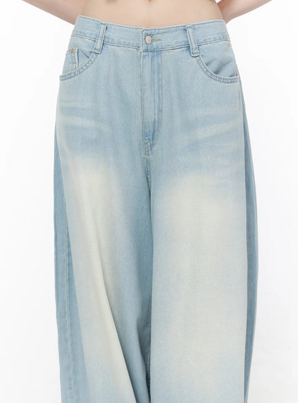Ozzy Washed Wide Leg Jeans CU519 in light blue, waist close-up on model, button fly, front pockets and sun-faded washed denim texture detail visible.