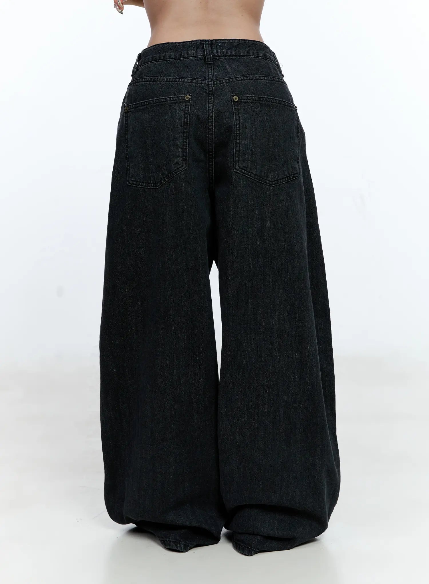 Wynter Star Embroidered Denim Jeans CG507 in black, back view cropped at waist, two patch pockets with rivet hardware, voluminous wide-leg hem pooling on the floor, washed cotton denim.