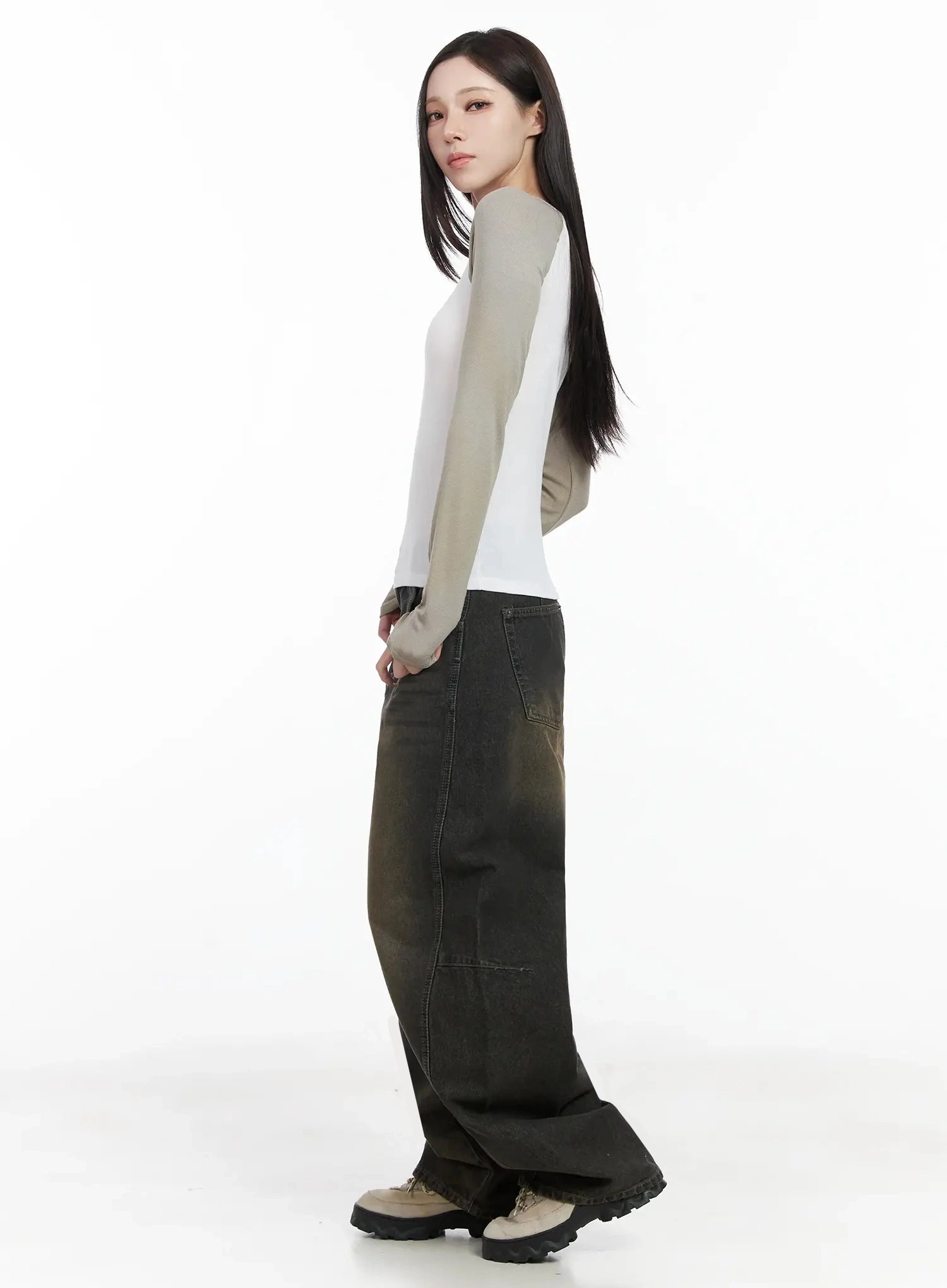Tracey Vintage Black Washed Wide Leg Jeans IJ528 in black, side full-body shot on model looking back, long wide-leg silhouette with brown vintage fade, paired with white raglan top, chunky boots.