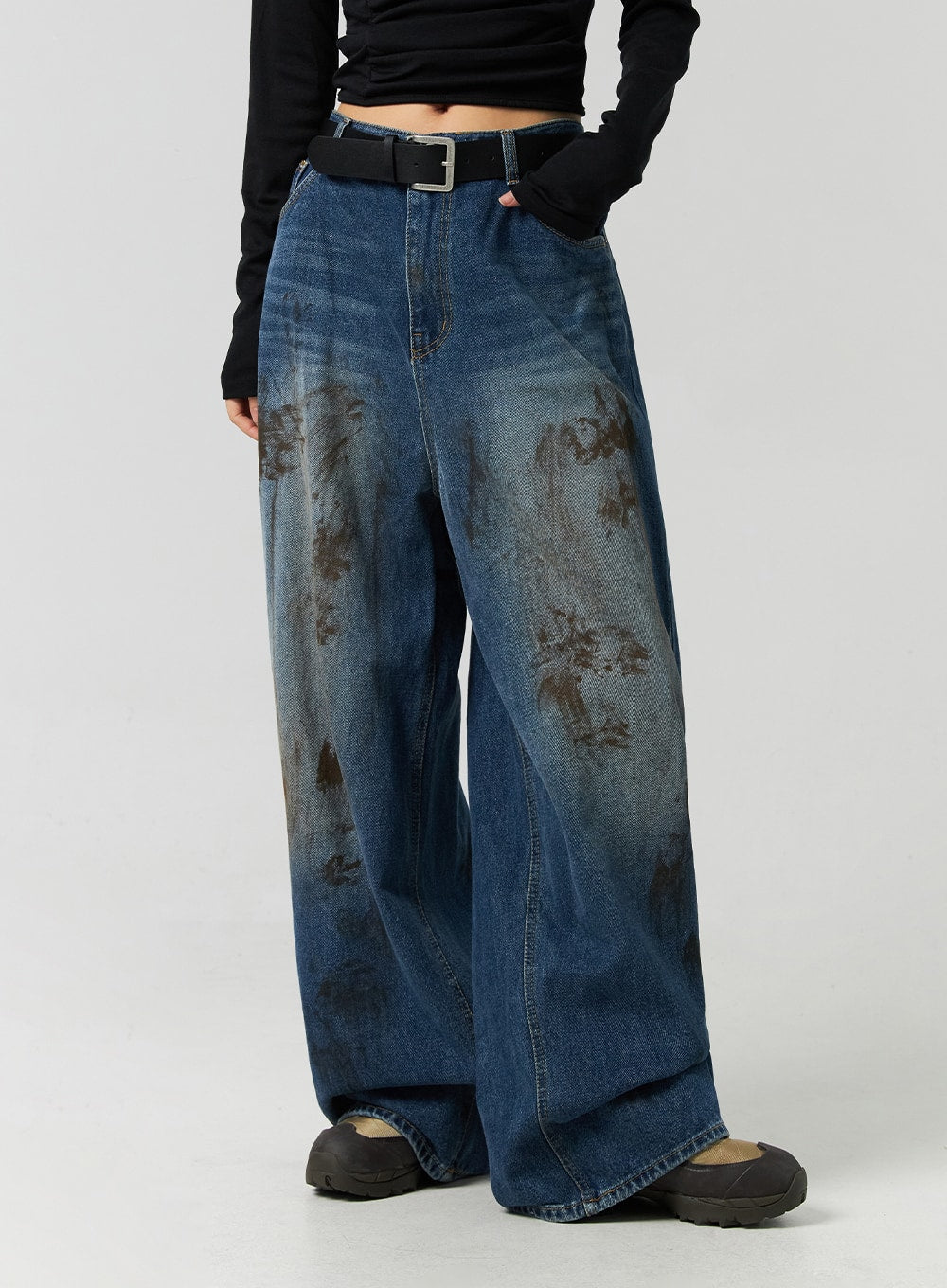 Street-Style Wide Fit Washed Jeans CO323 in Blue, side-front mid-shot on model, wide fit high-rise denim with visible seam lines and bold brown washed distress, paired with black belt.