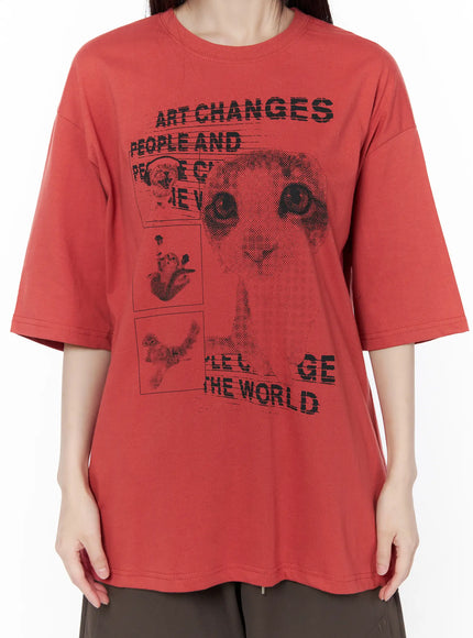 Oversized Cat Print Graphic Tee CU519 in dark red, close-up front torso shot, halftone cat collage print with 'Art Changes People And The World' text clearly visible on boxy cotton tee.