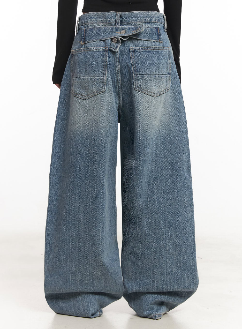 Yvette Washed Baggy Jeans IA517 in light blue, back full-length view on model, two large patch back pockets, crossover waistband detail, extra-wide leg with washed fade, paired with black crop top.