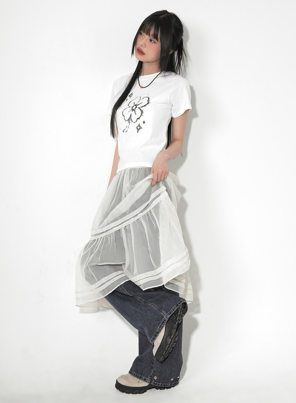 Bri Oversized Buttoned Baggy Jeans CF518 in dark blue, three-quarter front on model lifting sheer organza skirt overlay to reveal wide-leg denim, relaxed street style look.