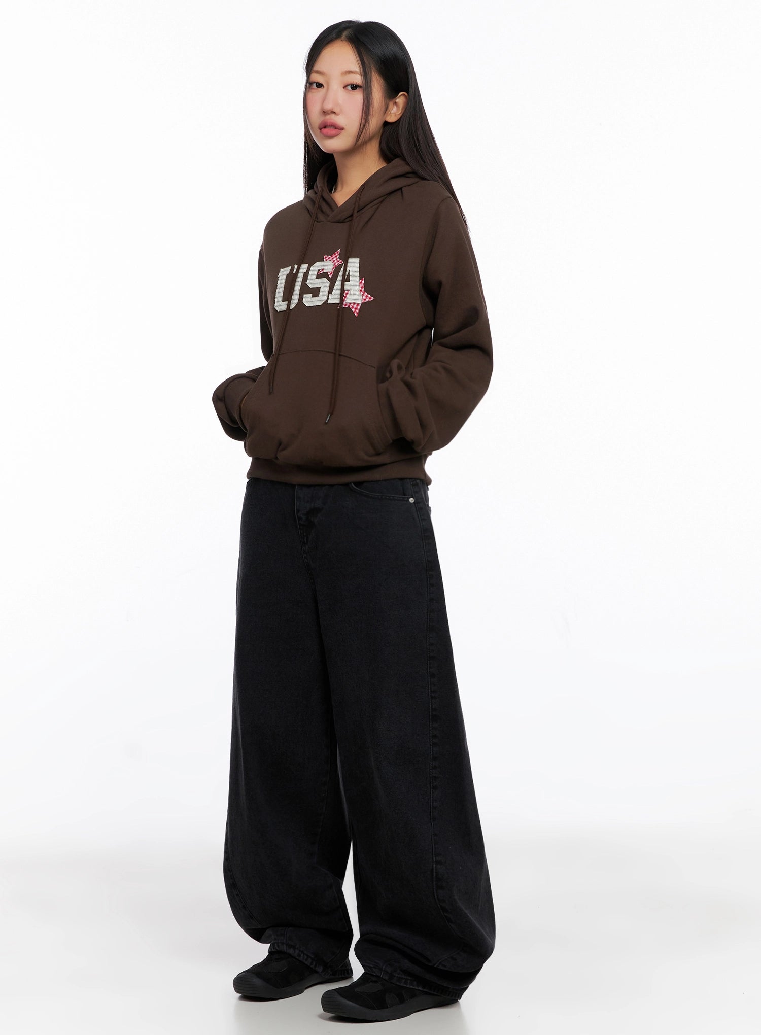 Sunwoo Embroidered Wide Leg Jeans IG528 in black, front three-quarter full-body on model, loose baggy cotton denim styled with brown graphic hoodie, street casual acubi look.