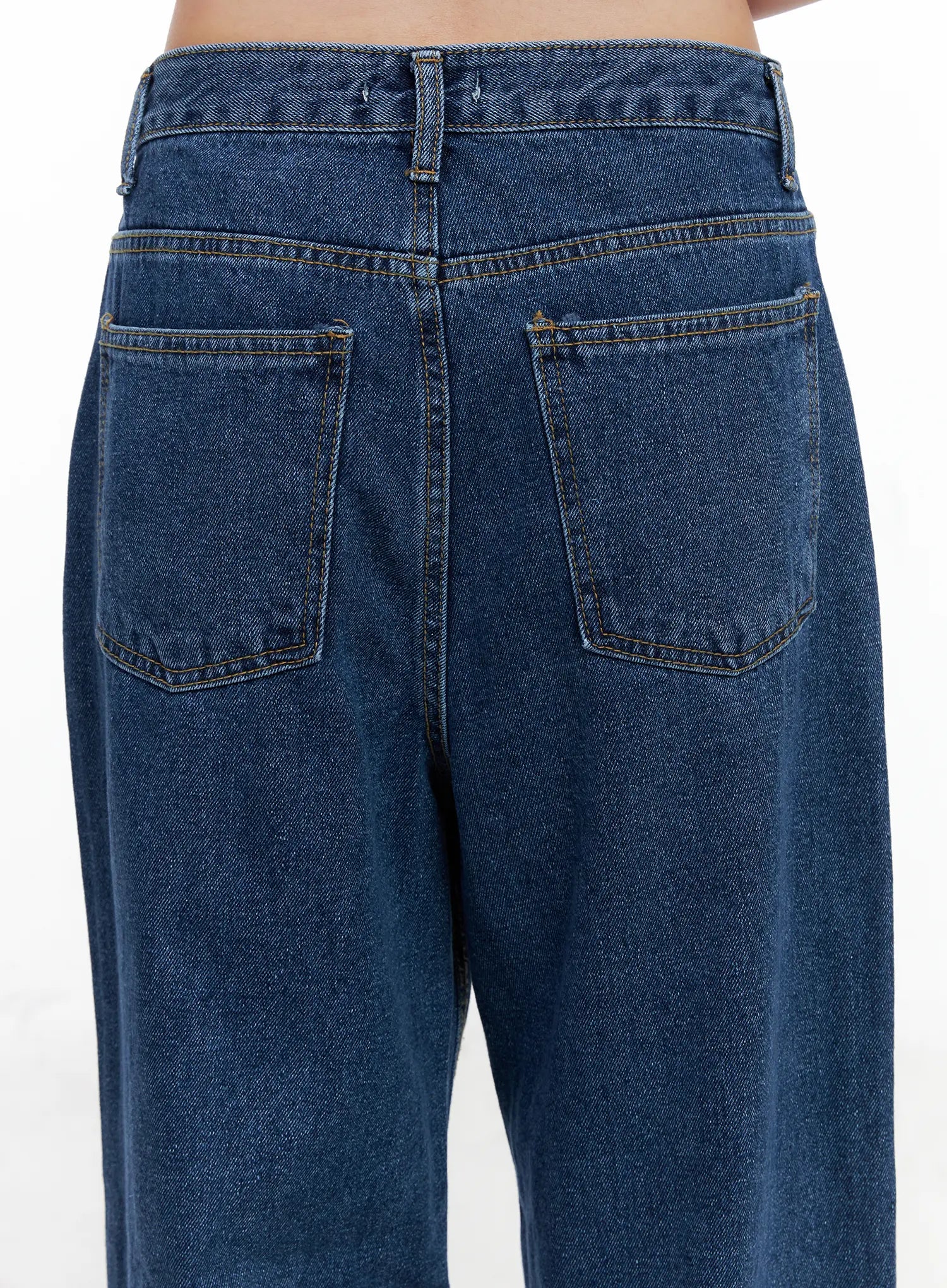 Eliza Seam Detail Relaxed Bootcut Jeans CO521 in washed blue, close-up back waistband and pocket detail, contrast topstitching on patch pockets, washed cotton denim texture visible.