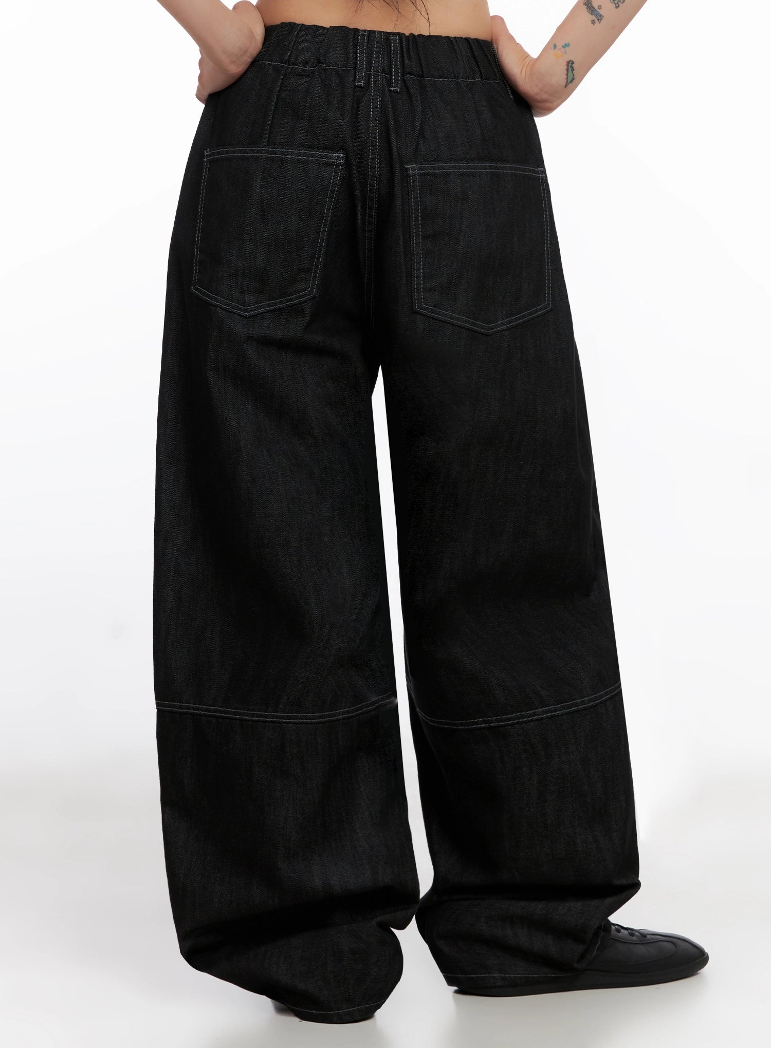 Leyla Pin-Tuck Wide-Leg Jeans IS515 in black, back view on model, elastic waistband with contrast stitch, large patch back pockets and pintuck knee seam on wide-leg cotton denim.