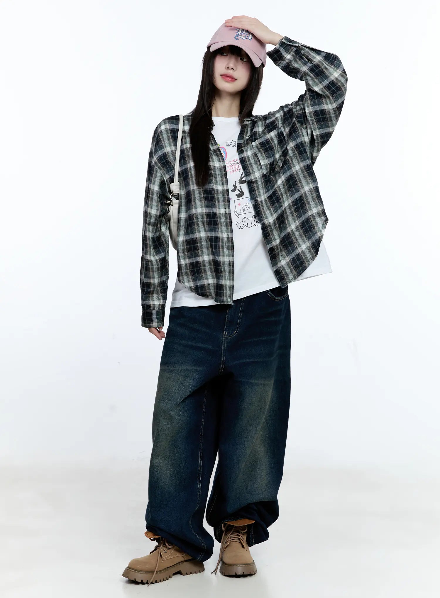 Jinnie Washed Wide-Leg Jeans CG511 in dark blue, full-body dynamic front shot on model, styled with open plaid shirt, white graphic tee, pink cap and crossbody bag, wide-leg denim with washed finish.