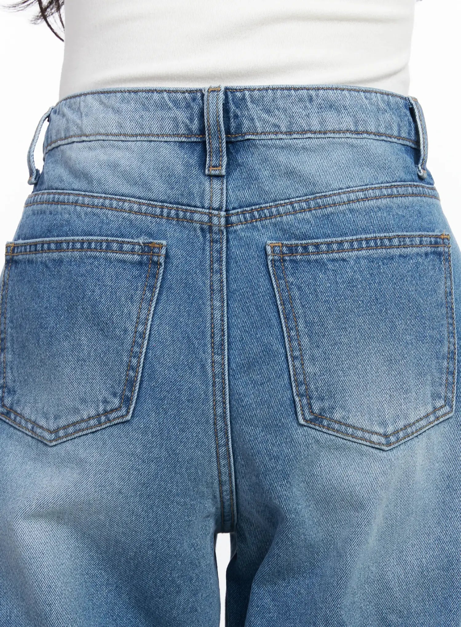 Iliana Wide Leg Jeans IJ529 in blue, macro close-up of back waistband and dual rear pockets, showing washed cotton texture, contrast topstitching and belt loops.
