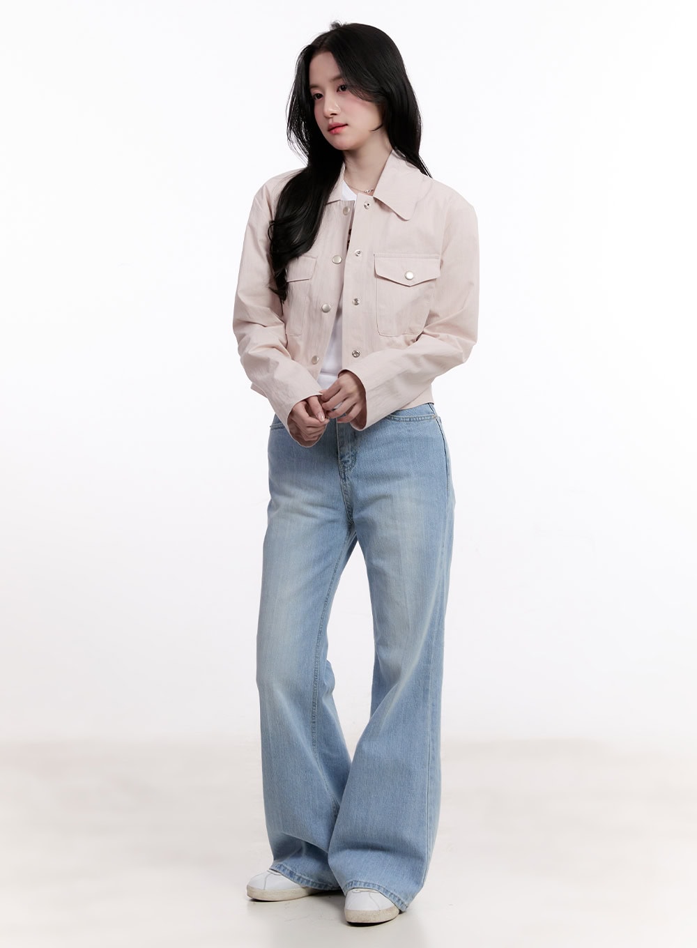 Daniella Relaxed-Fit Flared Jeans CM526 in light blue, full-body front shot on model, styled with cream cropped button-up jacket and white tee, flared hem grazes white sneakers.