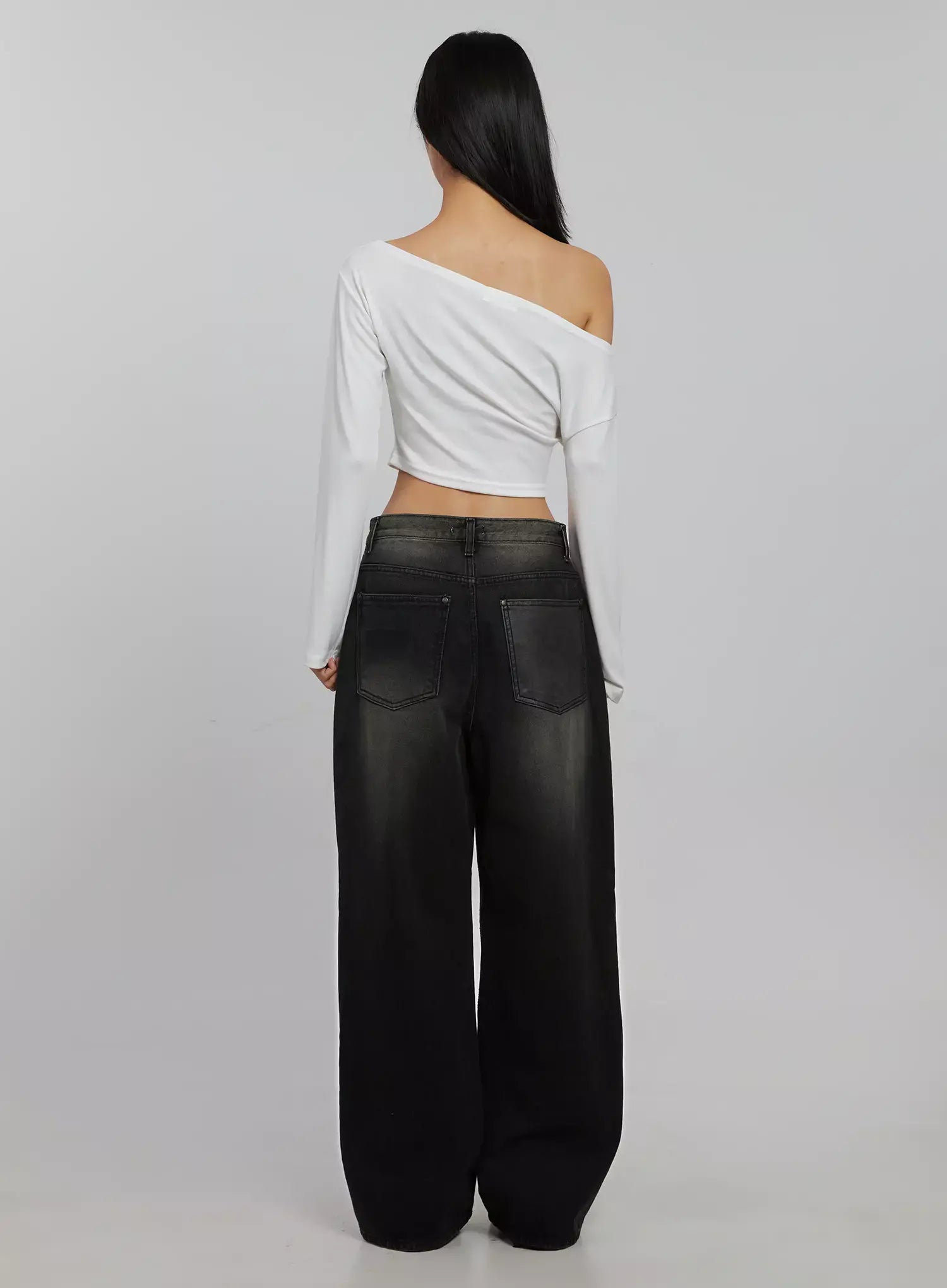 Blaire Dark Washed Wide Leg Jeans IJ509 in black, full back shot on model, dark washed wide leg cotton denim with two back patch pockets, faded gradient wash, styled with white off-shoulder crop top.