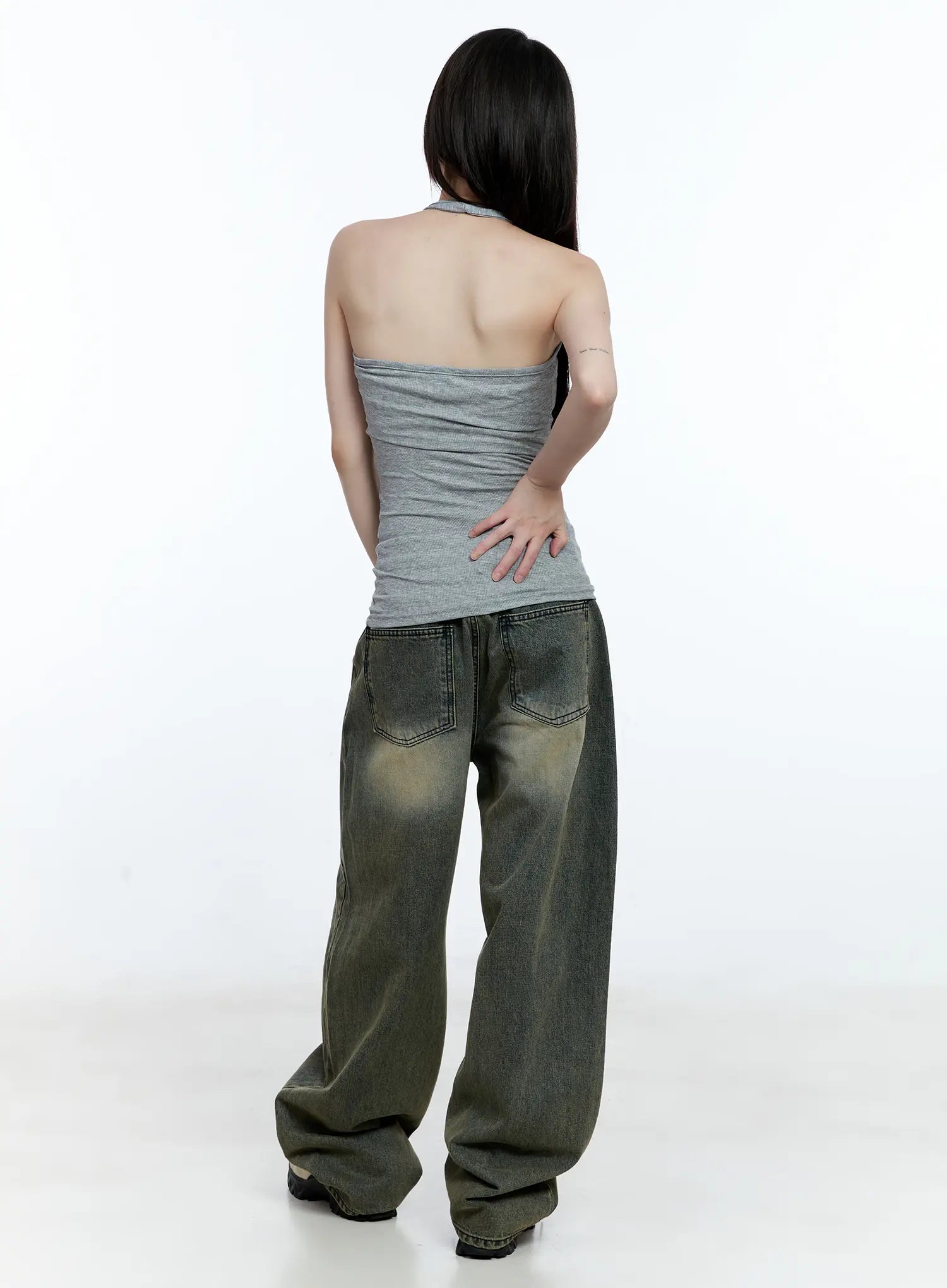 Yeonsoo Vintage-Wash Wide-Leg Jeans CG507 in vintage blue, back view on model in grey halter top, showing back pockets, wide-leg hem bunching at floor, contrast topstitching detail.