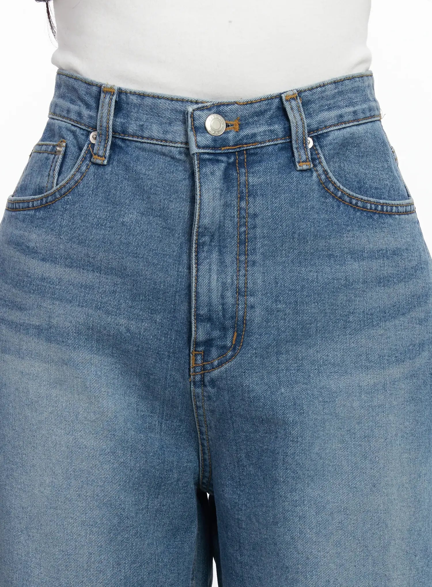 Ensley Wide Leg Jeans IJ529 in blue, close-up of waistband and front pockets, silver button fastening, contrast amber stitching, washed cotton texture detail.